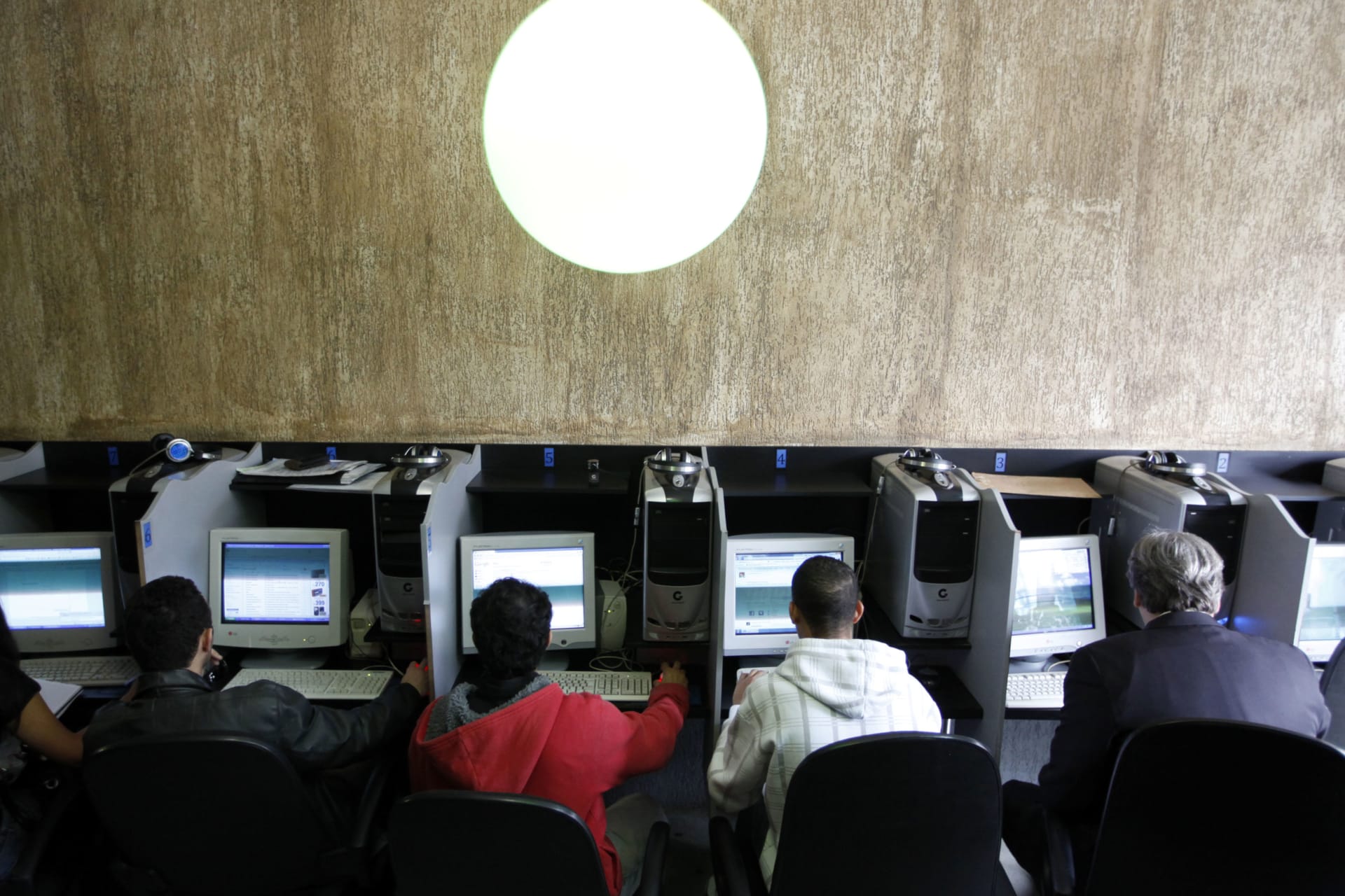 <p>Customers use computers at an internet cafe in Sao Paulo.</p>
