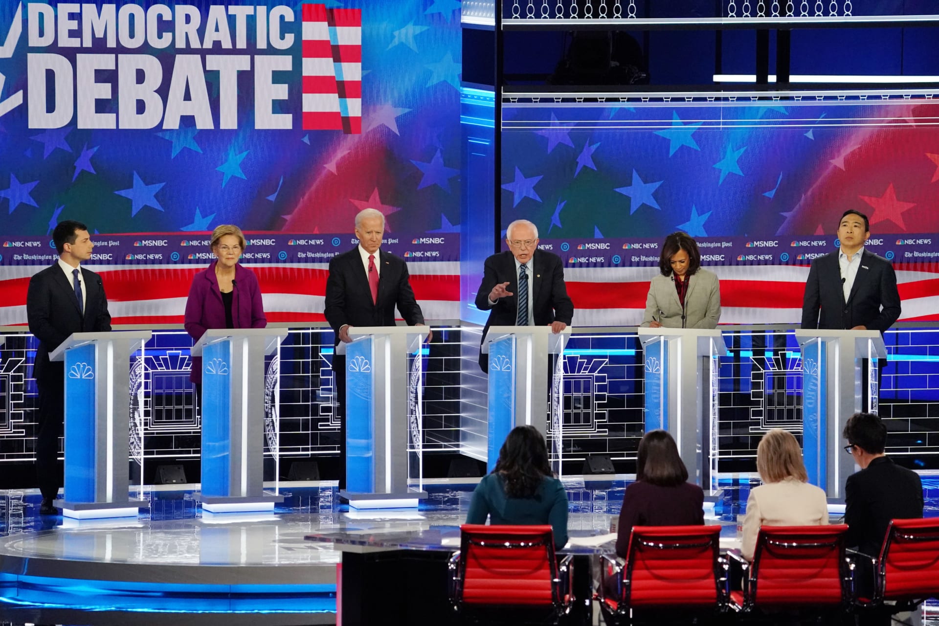 <p>Presidential candidates listen to Senator Bernie Sanders speak at the fifth Democratic debate in Atlanta on November 20. </p>
