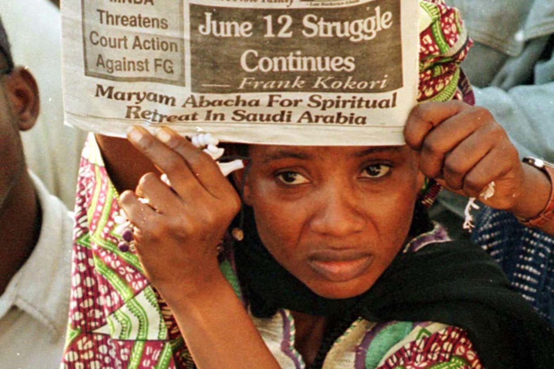 <p>A supporter of Chief Mashood Abiola holds up a newpaper during a demonstration outside the family home to protest about the suspicious nature of his death, on July 10, 1998. </p>
