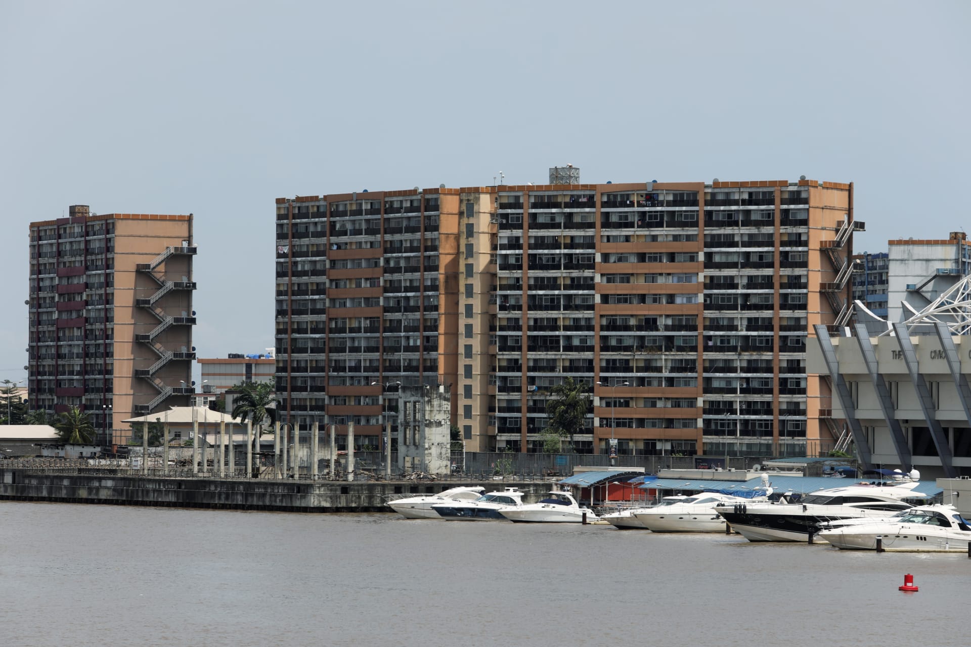 <p>Yachts seen docked at the marina in front of housing complex building in Lagos, Nigeria, on September 23, 2019.</p>

