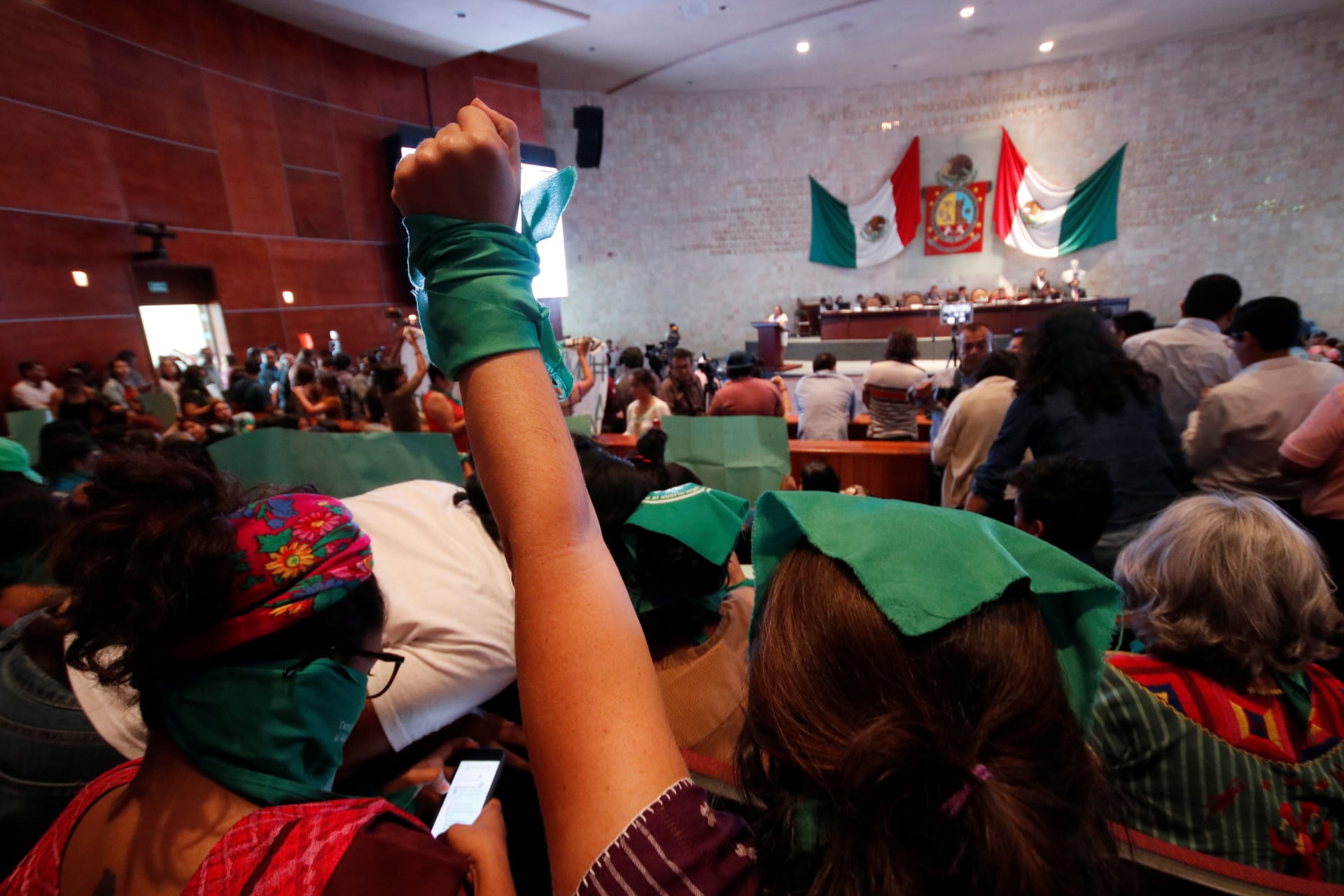 <p>A pro-choice demonstrator rises her fist during a session of the local congress as lawmakers are due to vote on legislation that decriminalized abortion in Oaxaca, Mexico September 25, 2019.</p>