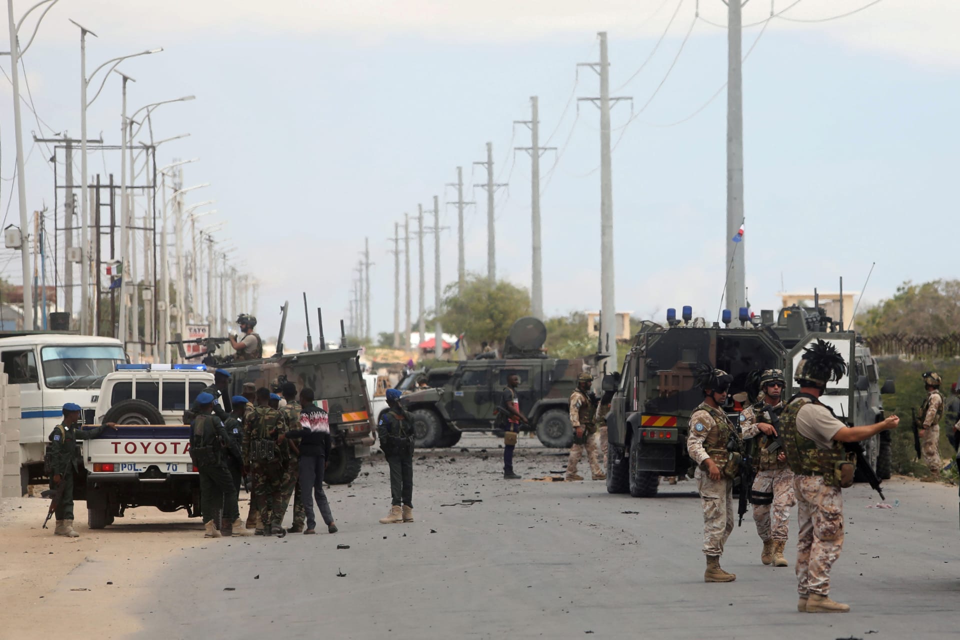 <p>Italian and Somali security forces are seen near armored vehicles at the scene of an attack on an Italian military convoy in Mogadishu, Somalia September 30, 2019</p>
