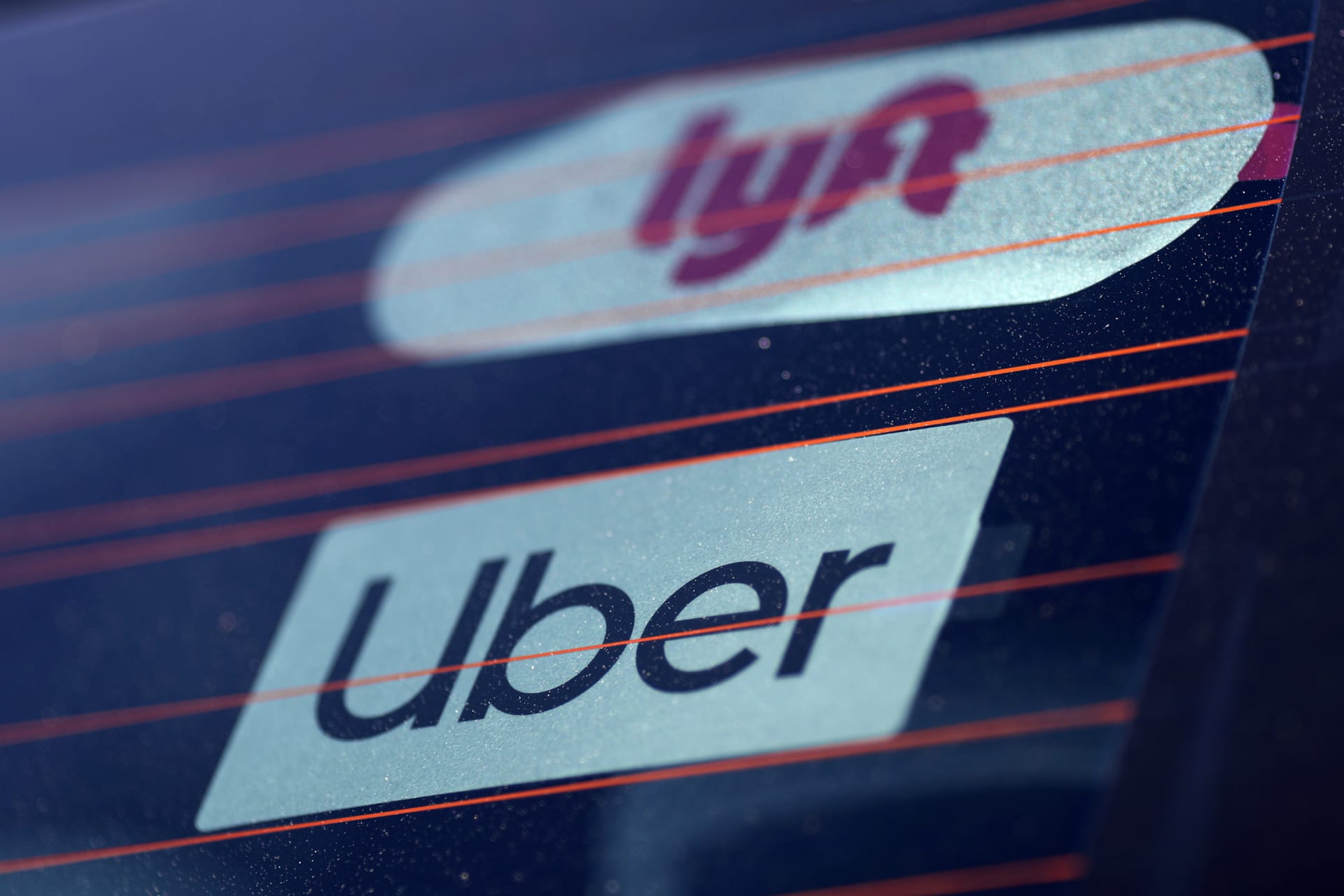 <p>Uber and Lyft signs are seen on a car in Redondo Beach, California, U.S., March 25, 2019.</p>