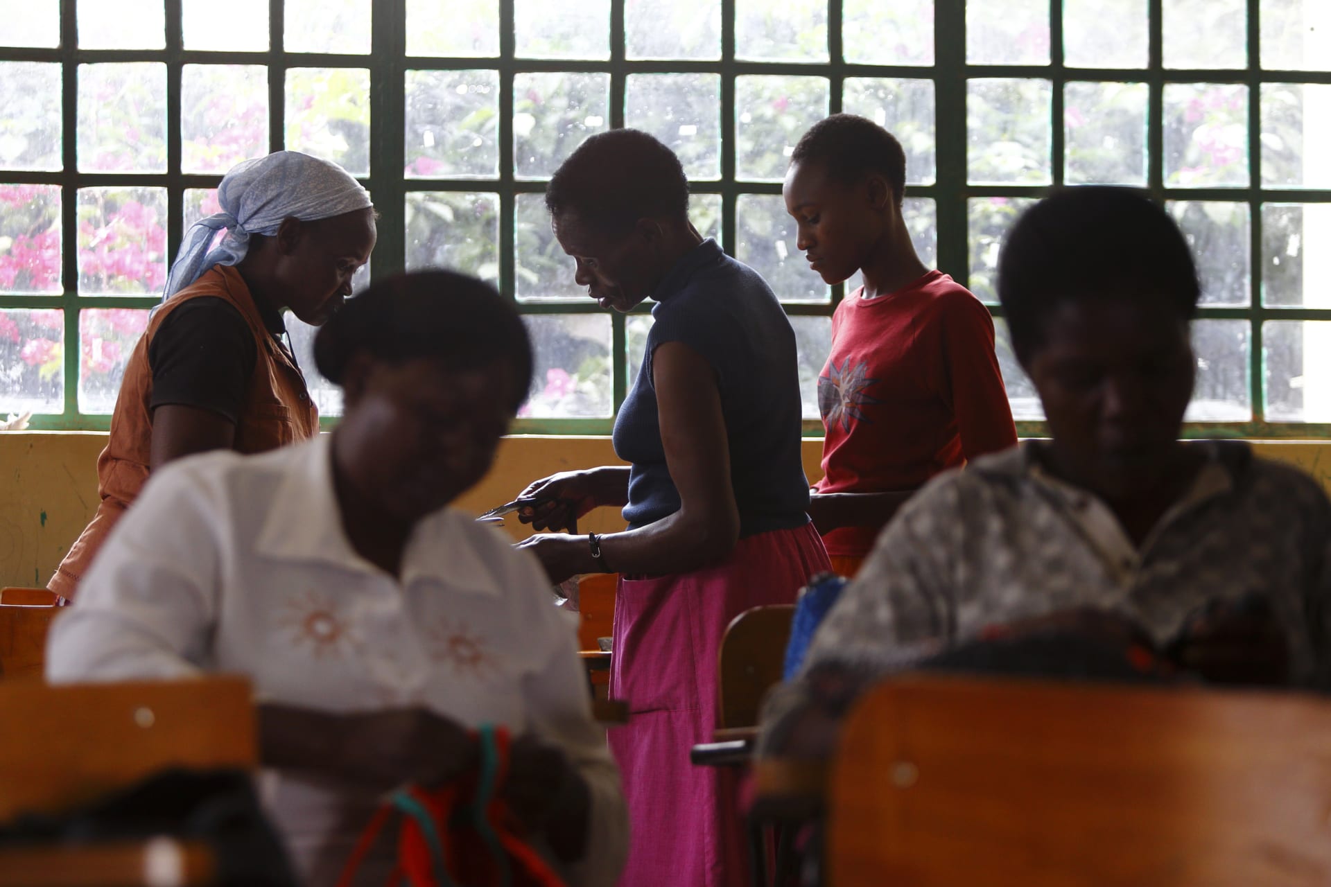 <p>Women weave polythene baskets at a community-based organisation in the Kibera slum of Nairobi that empowers women living with HIV/AIDS.</p>