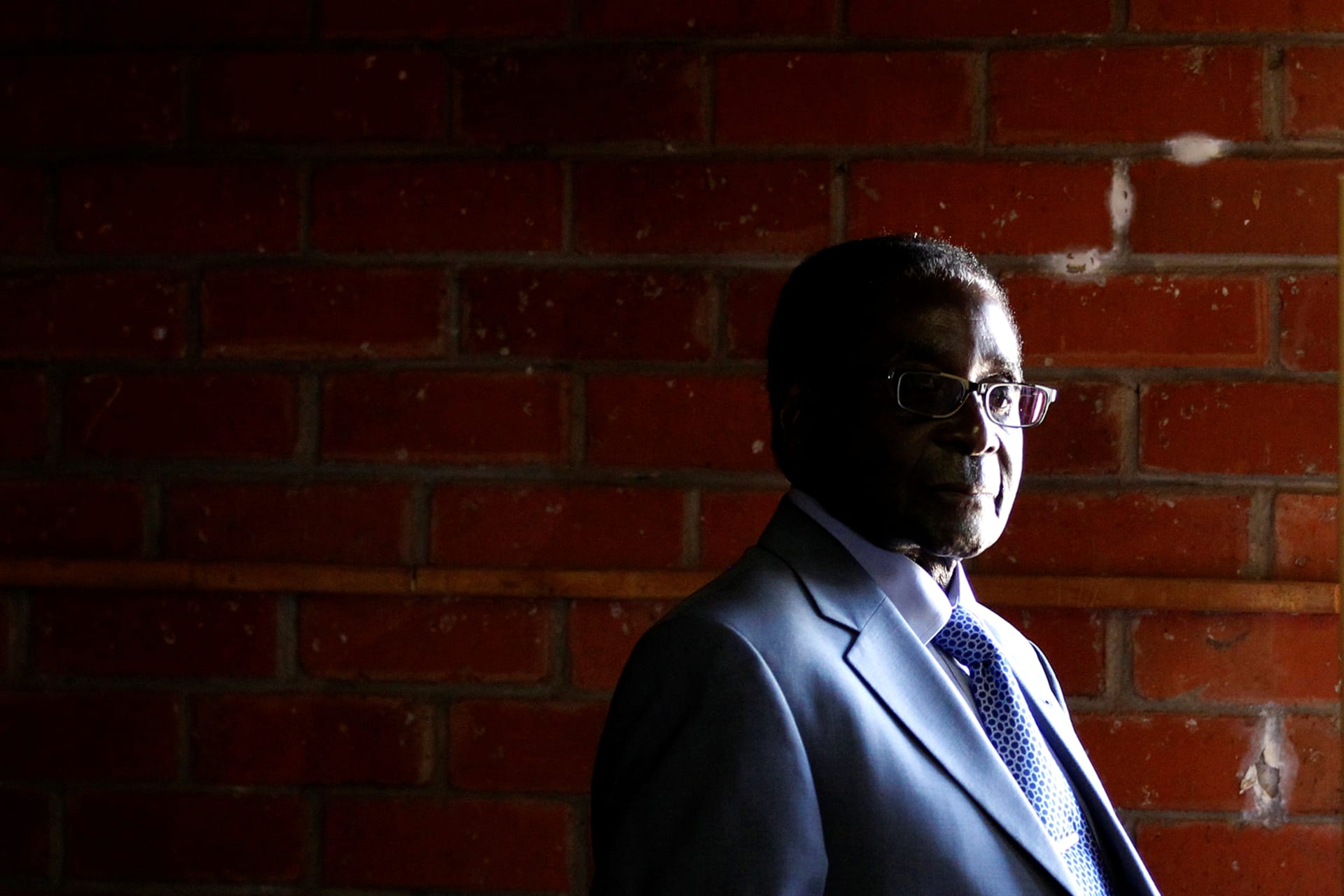 <p>Zimbabwe’s former President Robert Mugabe looks on before casting his vote in Highfields outside Harare on July 31, 2013</p>
