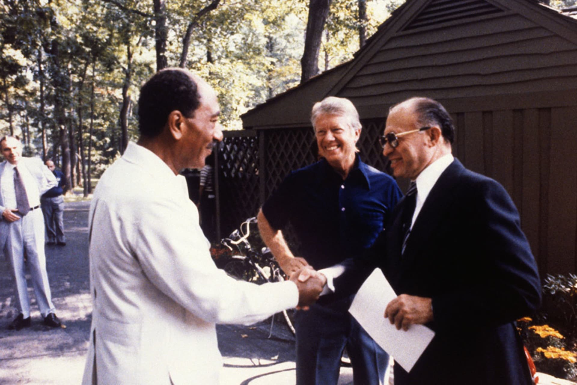 <p>Israeli Prime Minister Menachem Begin shakes hands with Egyptian President Anwar Sadat at the start of a trilateral meeting with U.S. President Jimmy Carter in 1978.</p>
