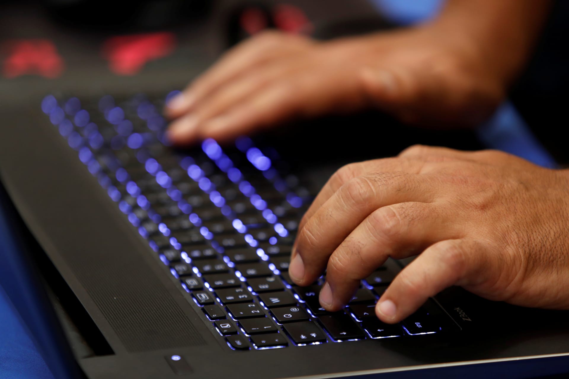 <p>A man types into a keyboard during a hacker convention on July 29, 2017. </p>