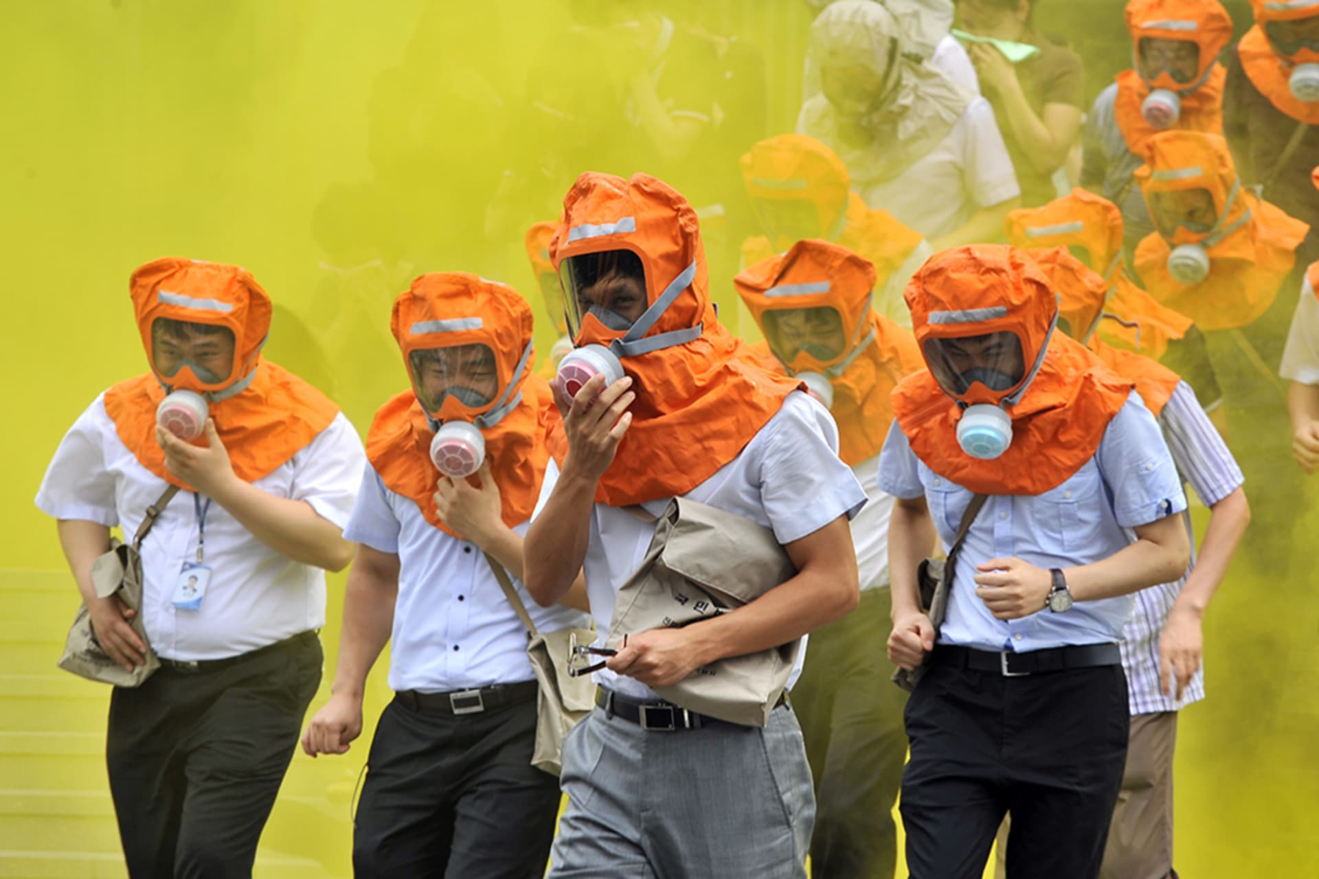 <p>South Koreans wearing gas masks run out of a building during a civil defense drill in Seoul.</p>
