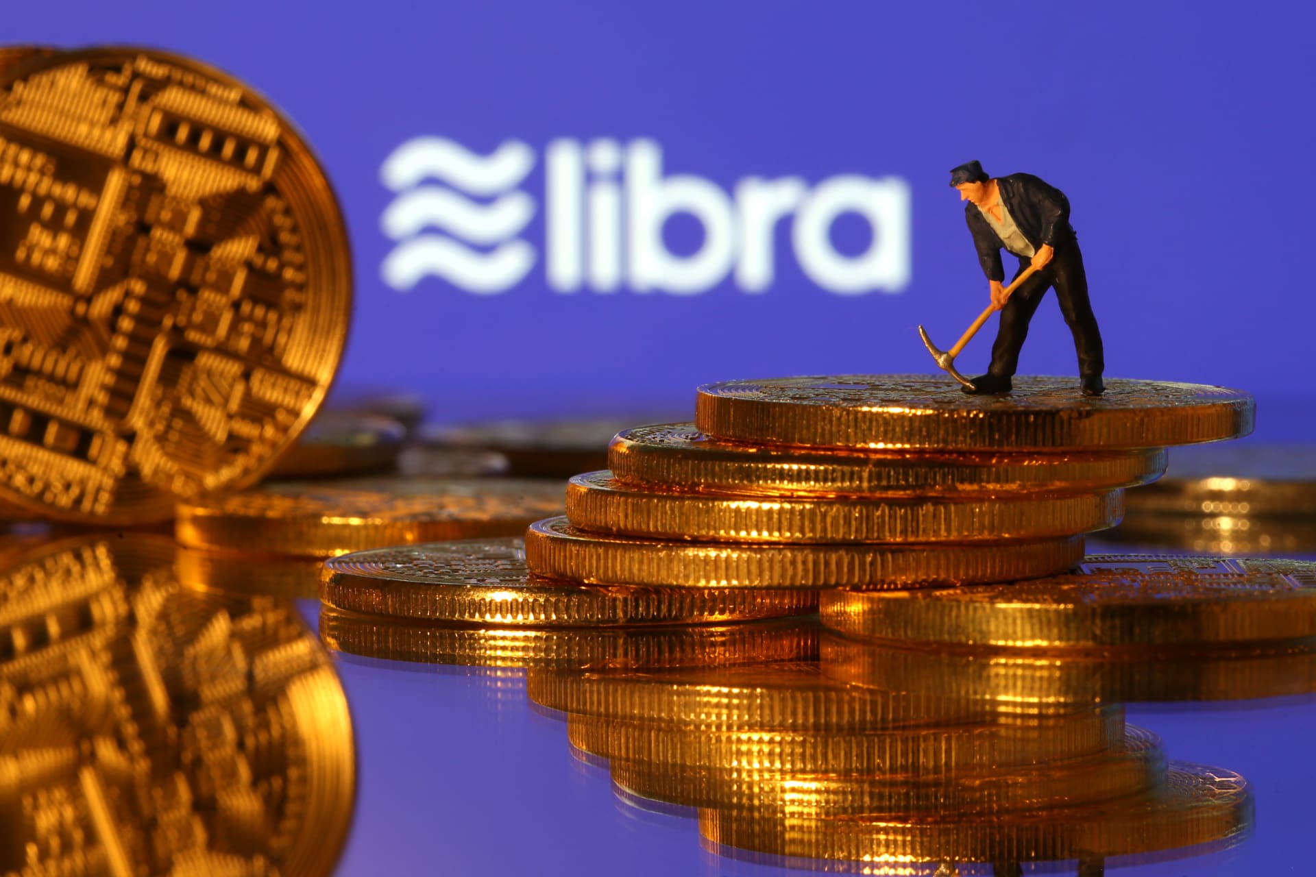 <p>A small toy figure stands on representations of virtual currency in front of the Libra logo in this illustration picture, June 21, 2019.</p>