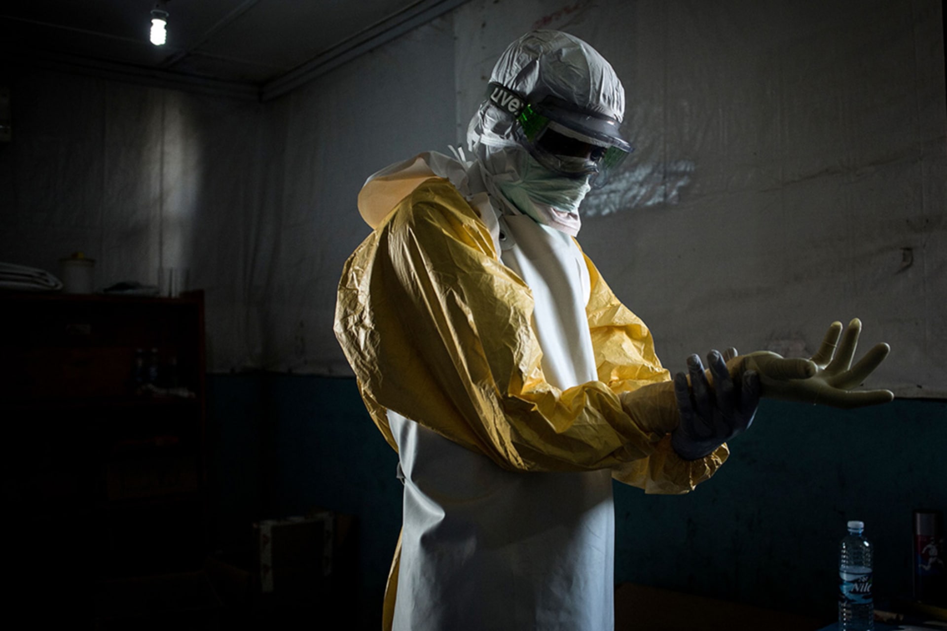 <p>A health worker puts on protective equipment before entering the red zone of an Ebola treatment center in Bunia, Democratic Republic of Congo.</p>
