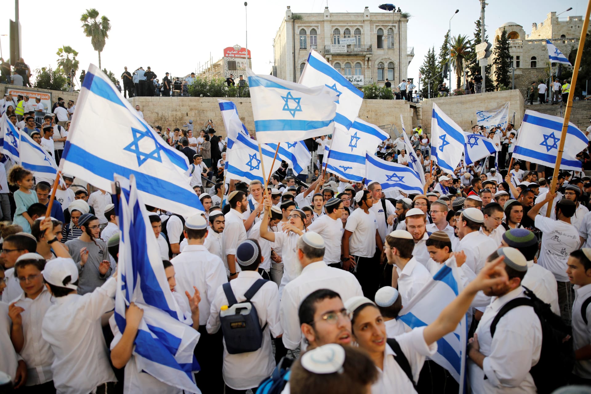 <p>Jewish youth wave Israeli flags as they participate in a march marking “Jerusalem Day”, near Damascus Gate in Jerusalem’s Old City June 2, 2019.</p>