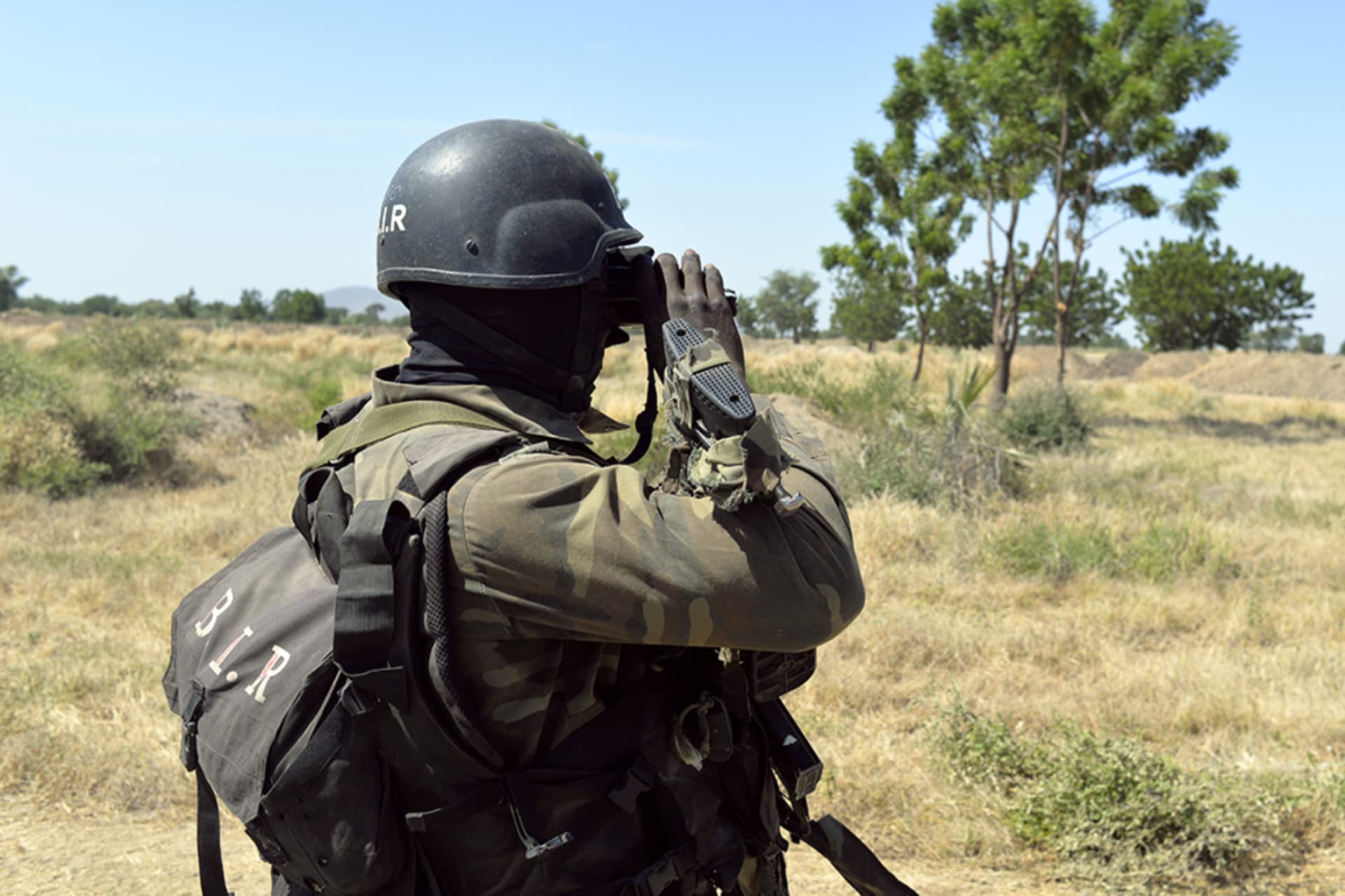 <p>A Cameroonian soldier looks at the border through binoculars on November 12, 2014, in Amchide, northern Cameroon, one kilometer from Nigeria.</p>
