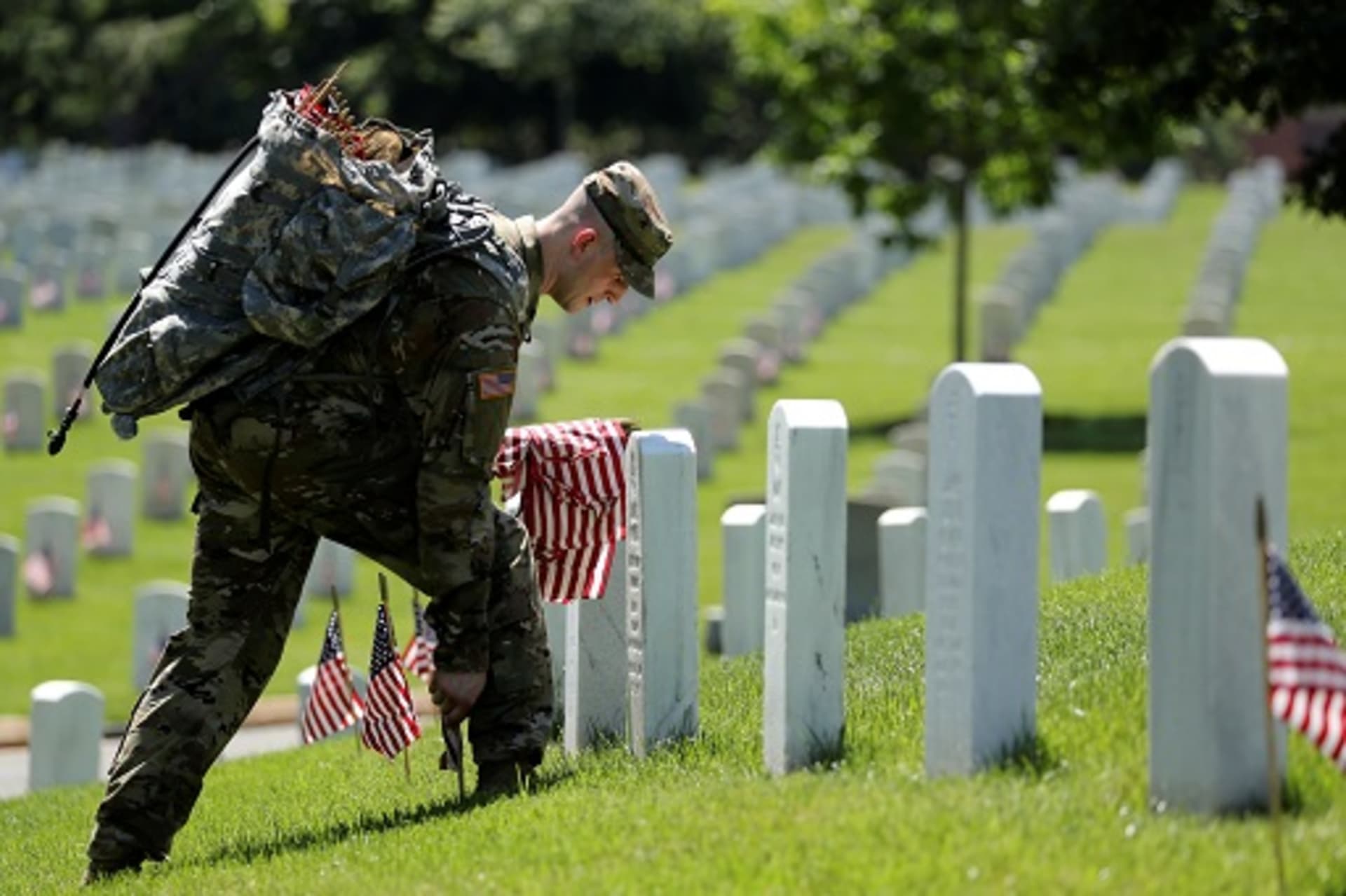 <p>U.S. Army soldiers of the 3rd United States Infantry Regiment place U.S. flags on graves at Arlington National Cemetery, U.S. May 24, 2018. </p>
