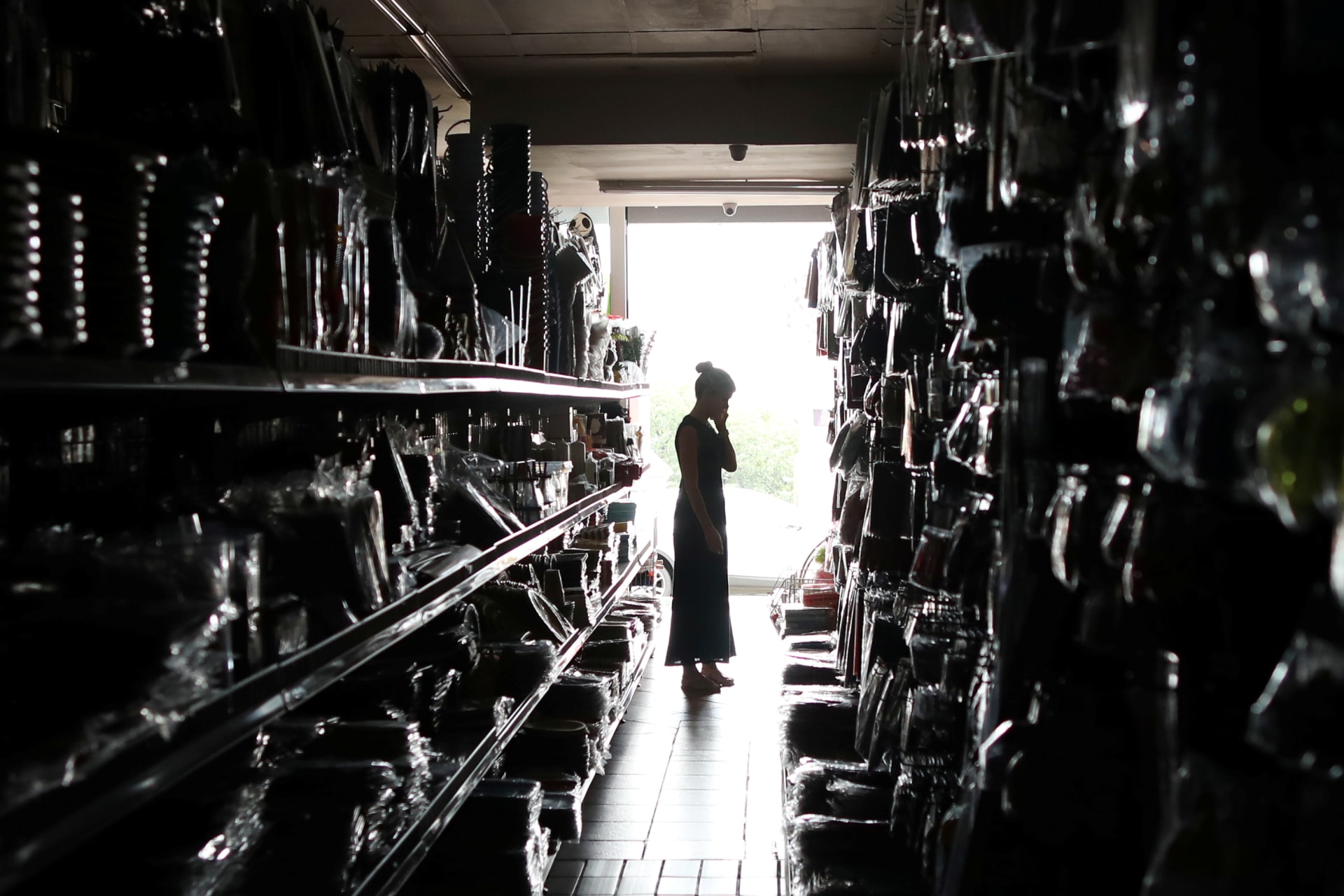 <p>A shopper looks for goods during an electricity load-shedding blackout in Johannesburg, South Africa, February 12, 2019.</p>
