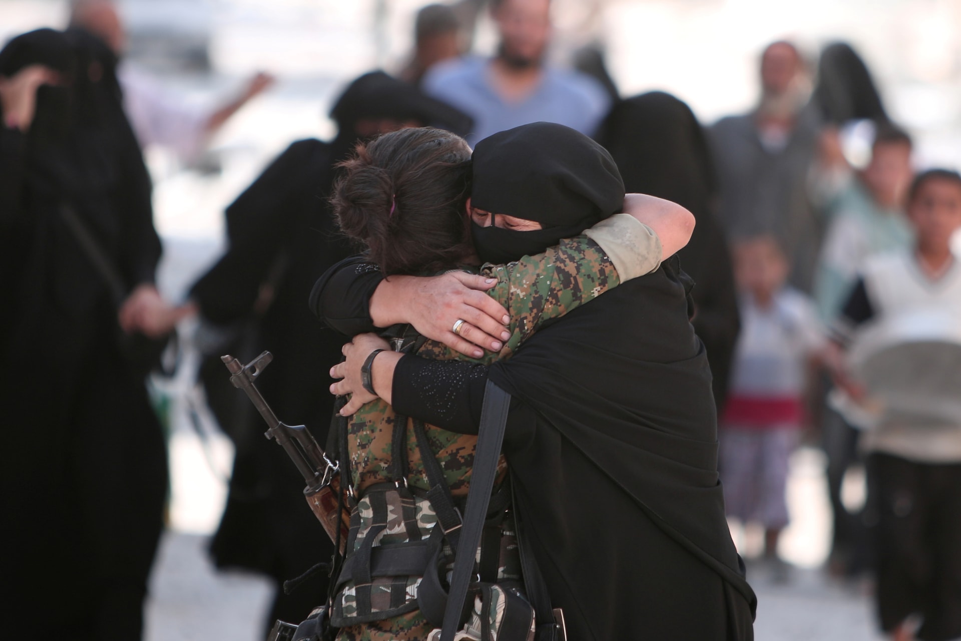 <p>A woman embraces a Syria Democratic Forces (SDF) fighter after she was evacuated with others by the SDF from an Islamic State-controlled neighbourhood of Manbij, in Aleppo Governorate, Syria, August 12, 2016.</p>
