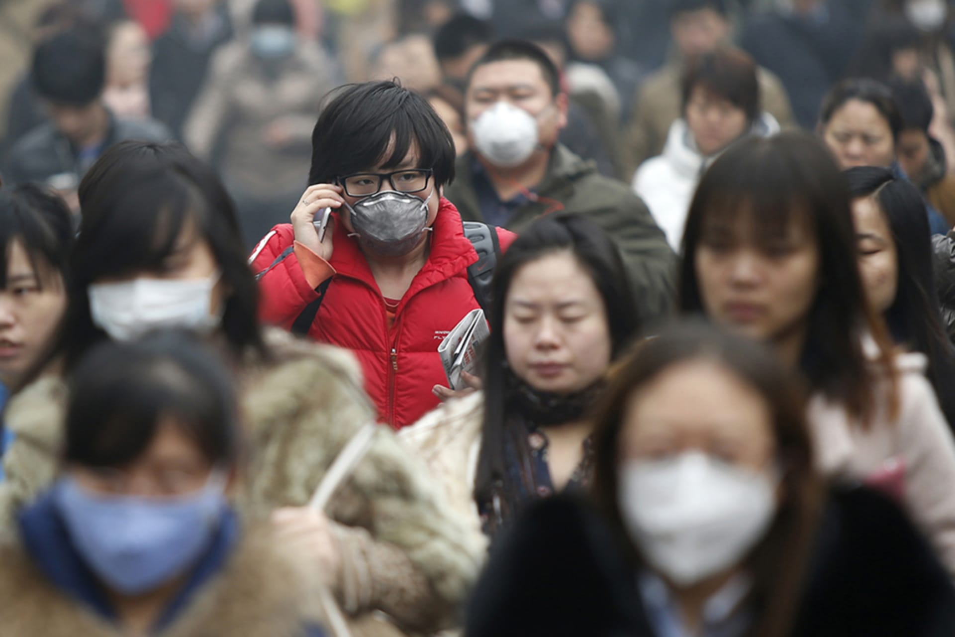 <p>Commuters wearing masks make their way amid thick haze in the morning in Beijing, China.</p>
