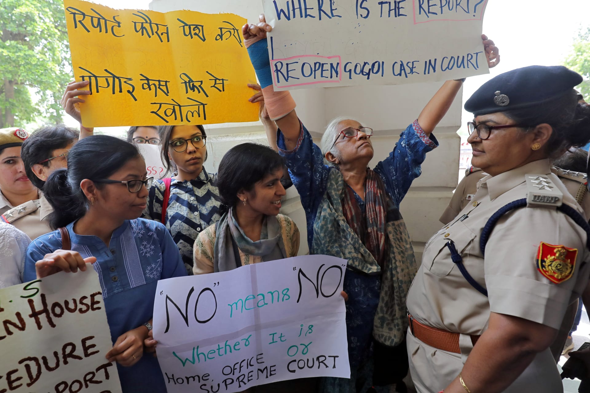<p>Demonstrator hold placards during a protest after a panel of judges dismissed a sexual harassment complaint against Chief Justice of India (CJI) Ranjan Gogoi in New Delhi, India, May 8, 2019.</p>
