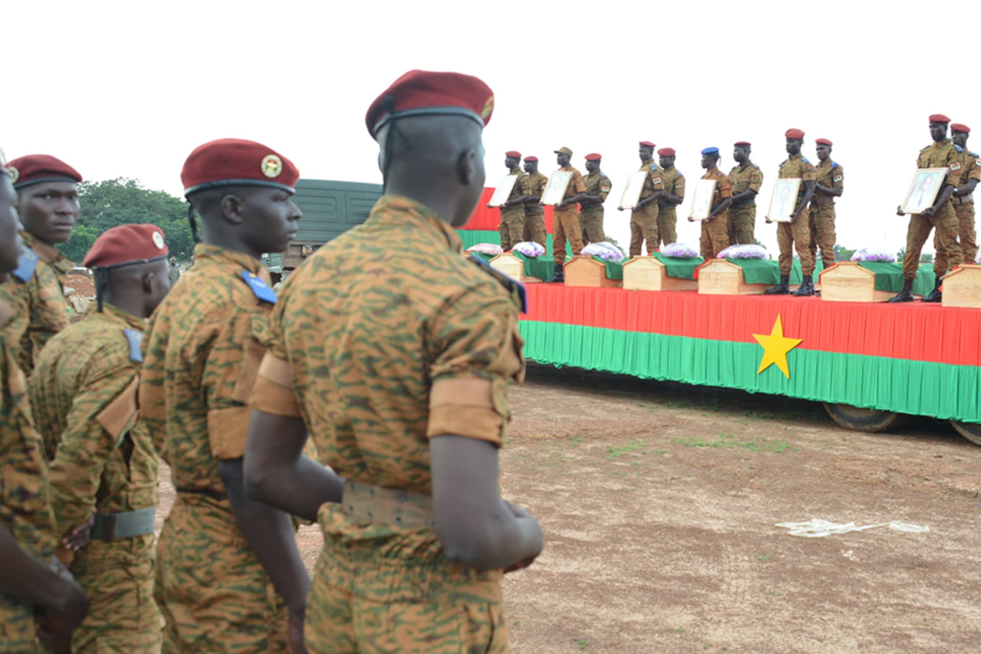 <p>Soldiers take part in the funeral ceremony of the seven members of the security forces killed three days ago after their vehicle struck a roadside bomb in eastern Burkina Faso, on August 31, 2018, in Ouagadougou.</p>
