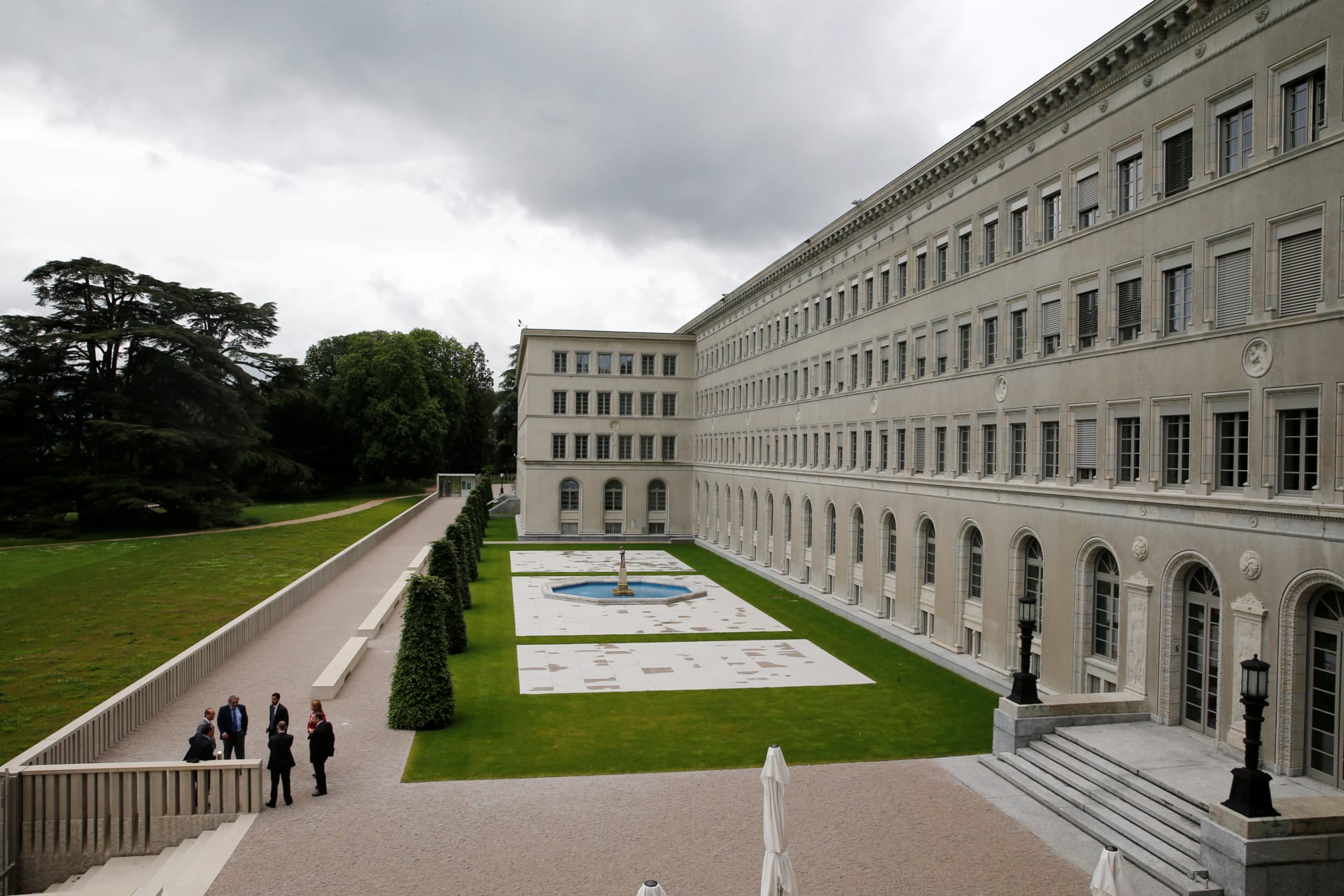 <p>People talk outside the headquarters of the World Trade Organization (WTO) in Geneva, Switzerland, June 3, 2016.</p>

