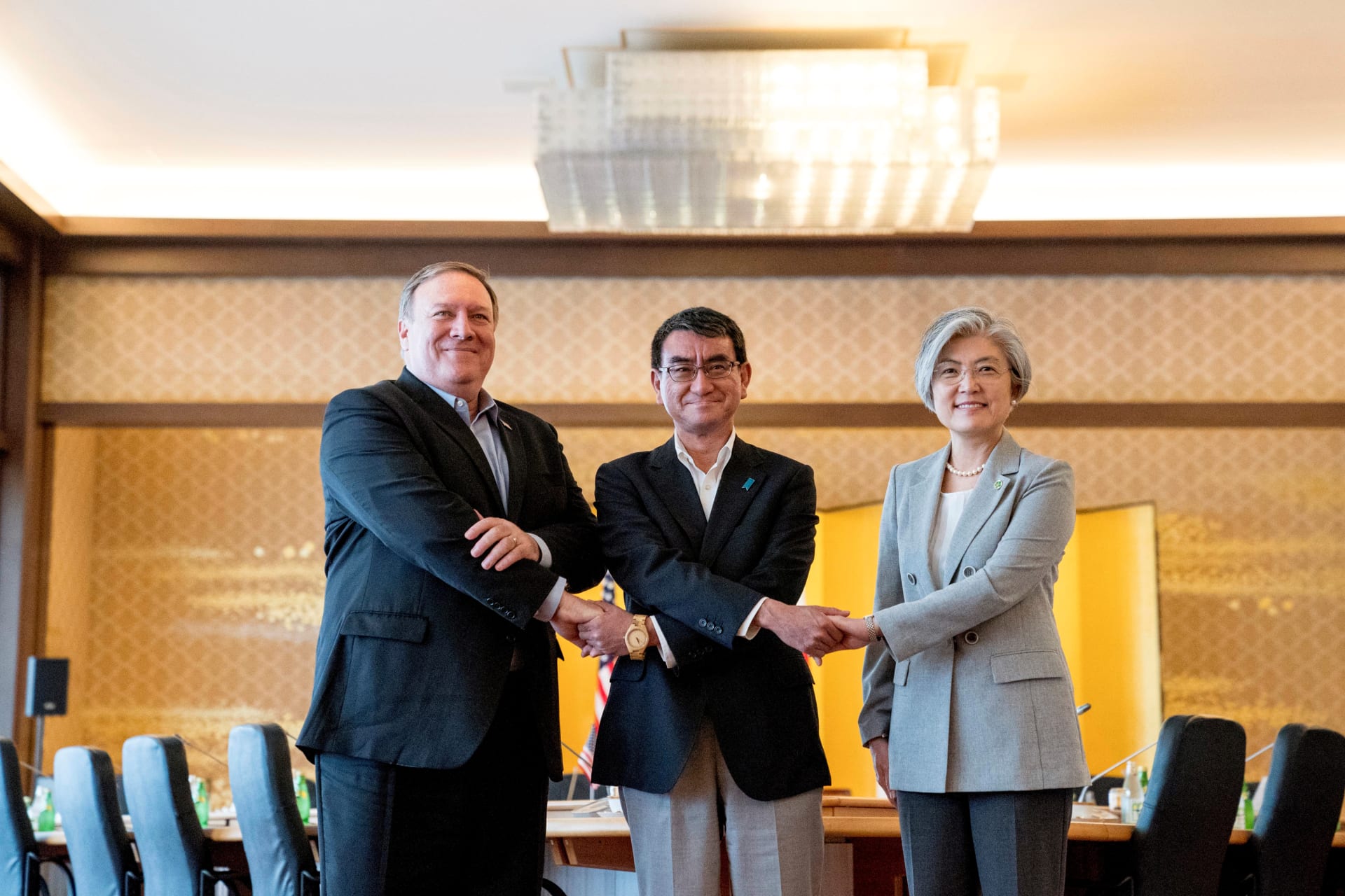 <p>U.S. Secretary of State Mike Pompeo, Japan’s Foreign Minister Taro Kono, and South Korea’s Foreign Minister Kang Kyung-wha shake hands as they meet in Tokyo, Japan on July 8, 2018.</p>
