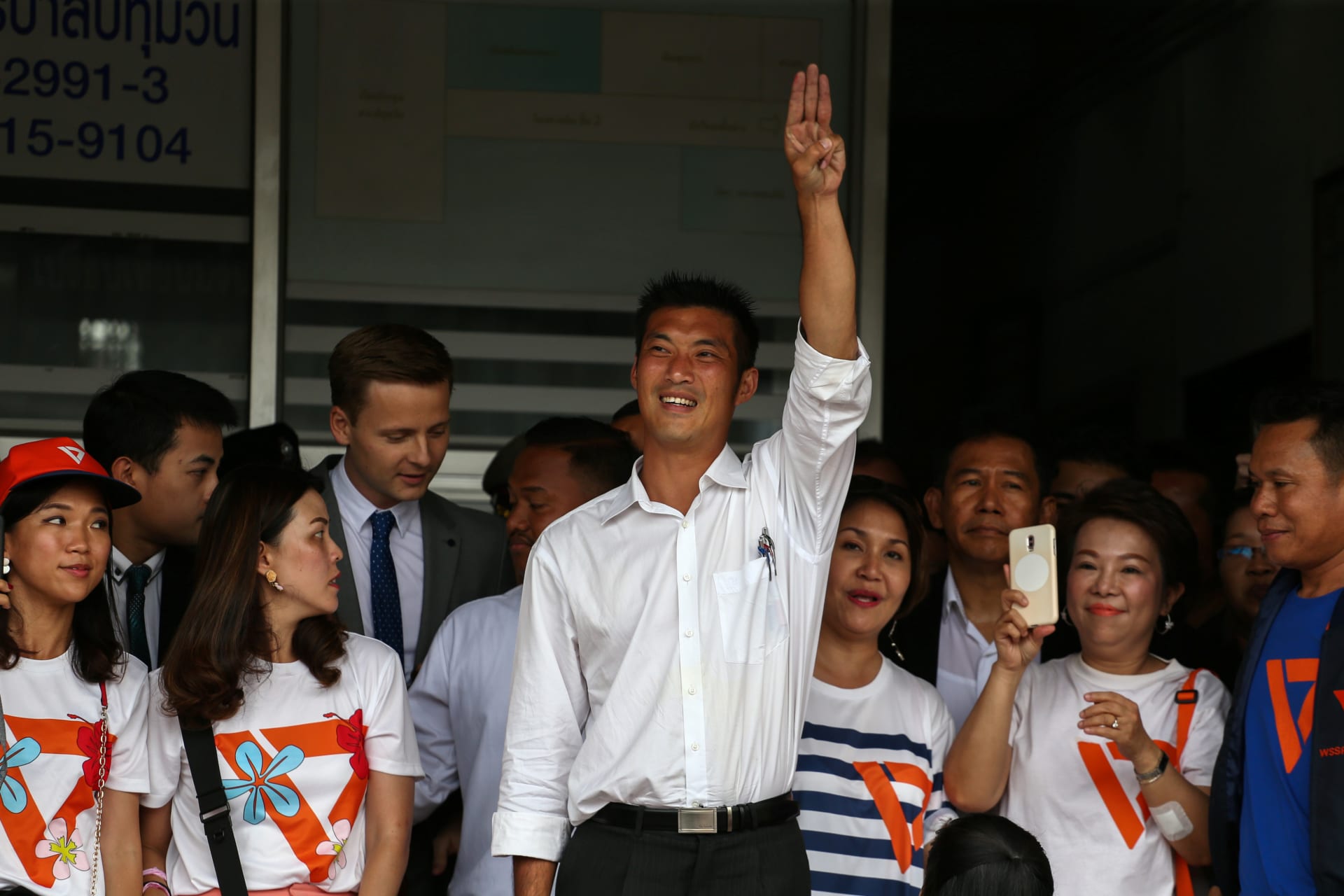 <p>Thanathorn Juangroongruangkit, leader of the Future Forward Party, flashes a three-finger salute to his supporters as he leaves a police station after hearing a sedition complaint filed by the army in Bangkok, Thailand, on April 6, 2019.</p>
