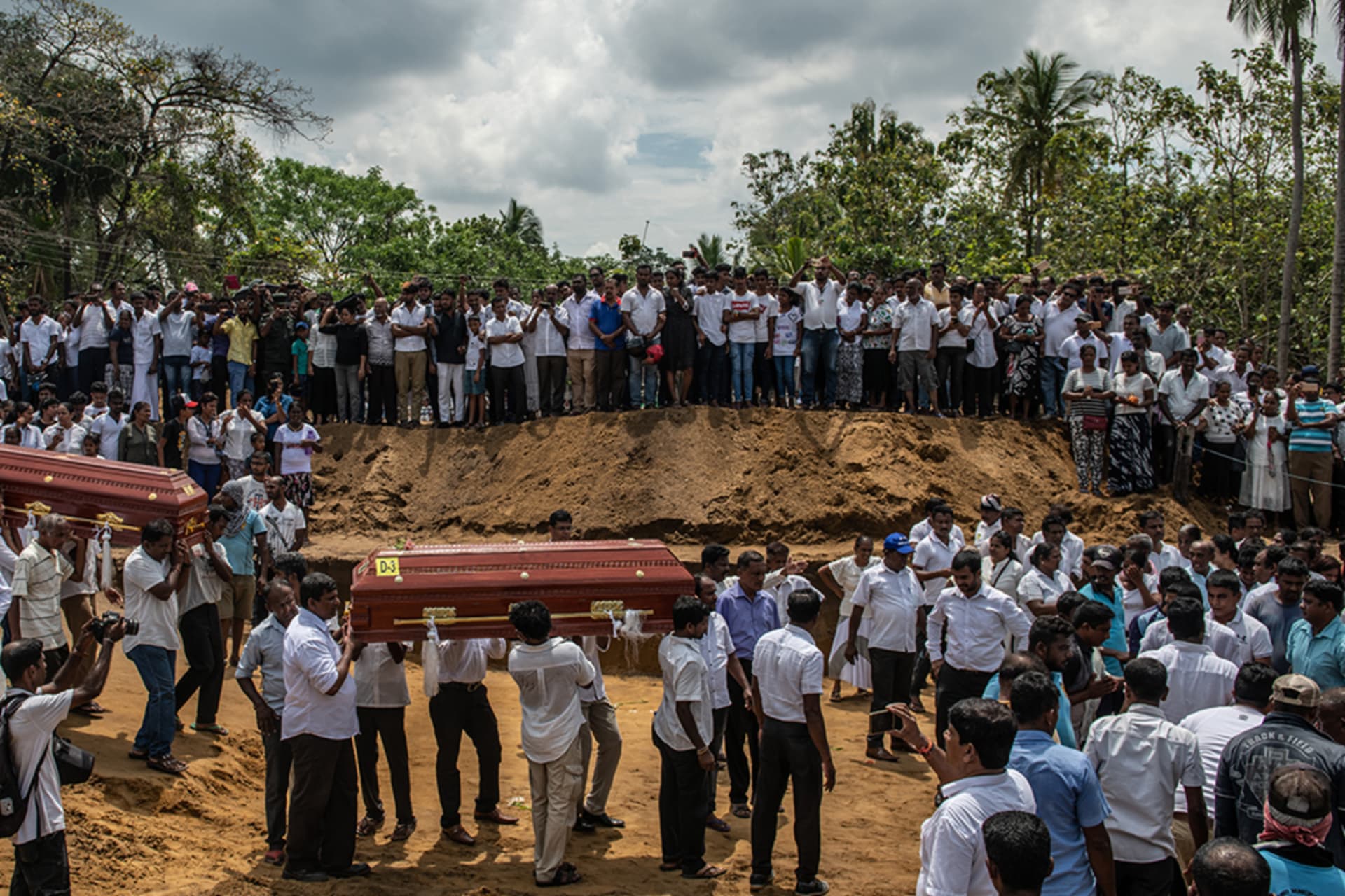 <p>Mourners carry the coffins of victims of the Sri Lanka bombings in April. </p>
