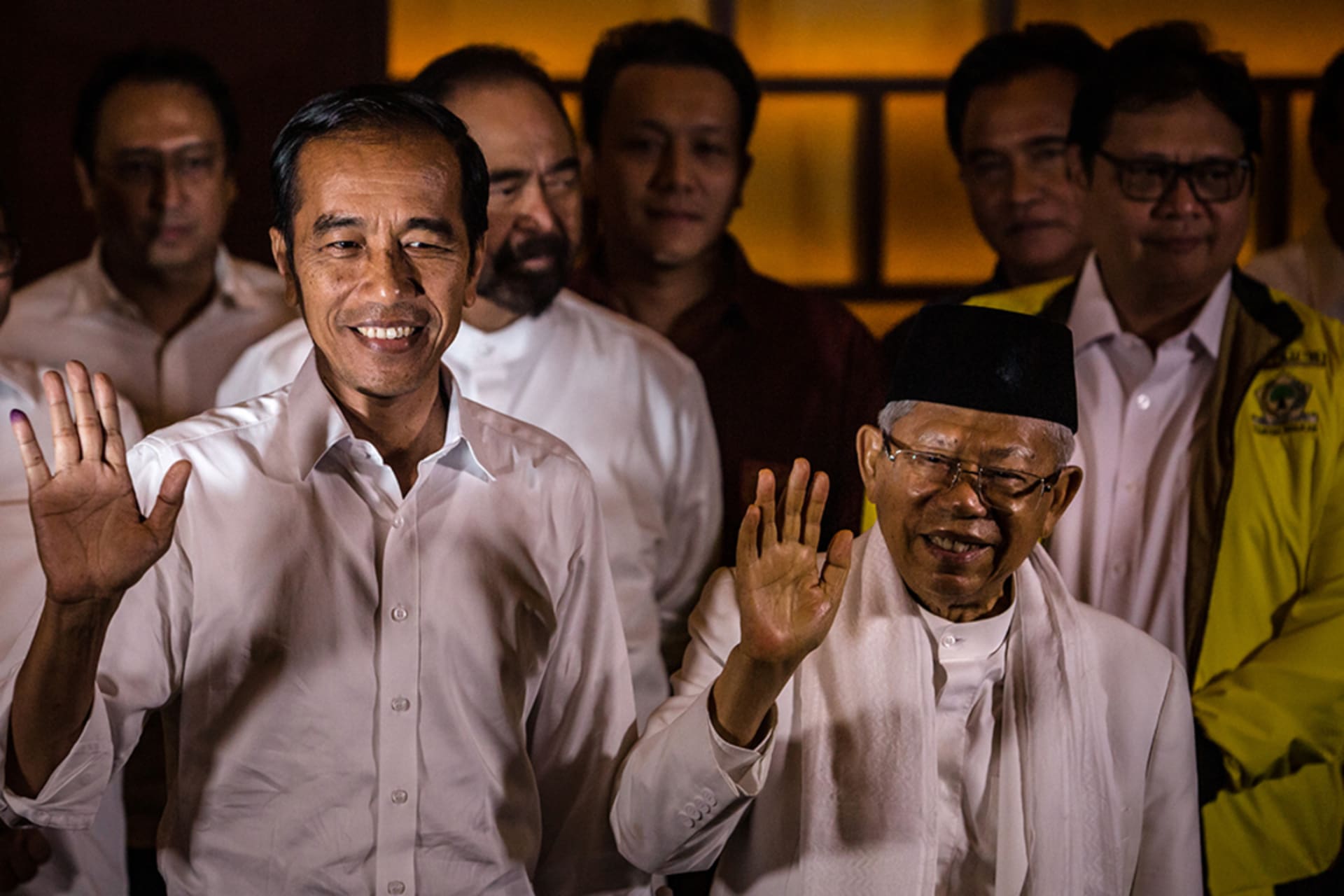 <p>President Joko Widodo and his vice presidential candidate Maruf Amin (R) wave during a press conference after Indonesia’s election.</p>
