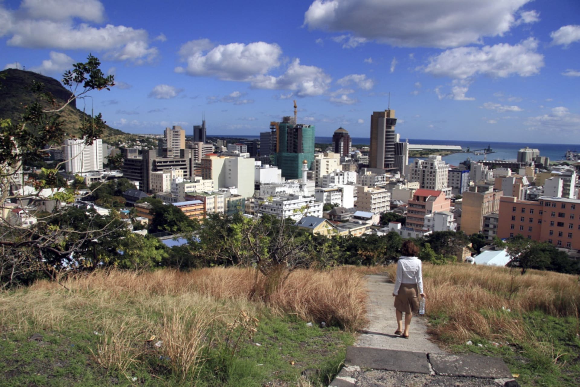 <p>A woman walks down a hill to Port Louis on June 6, 2008, in Mauritius.</p>
