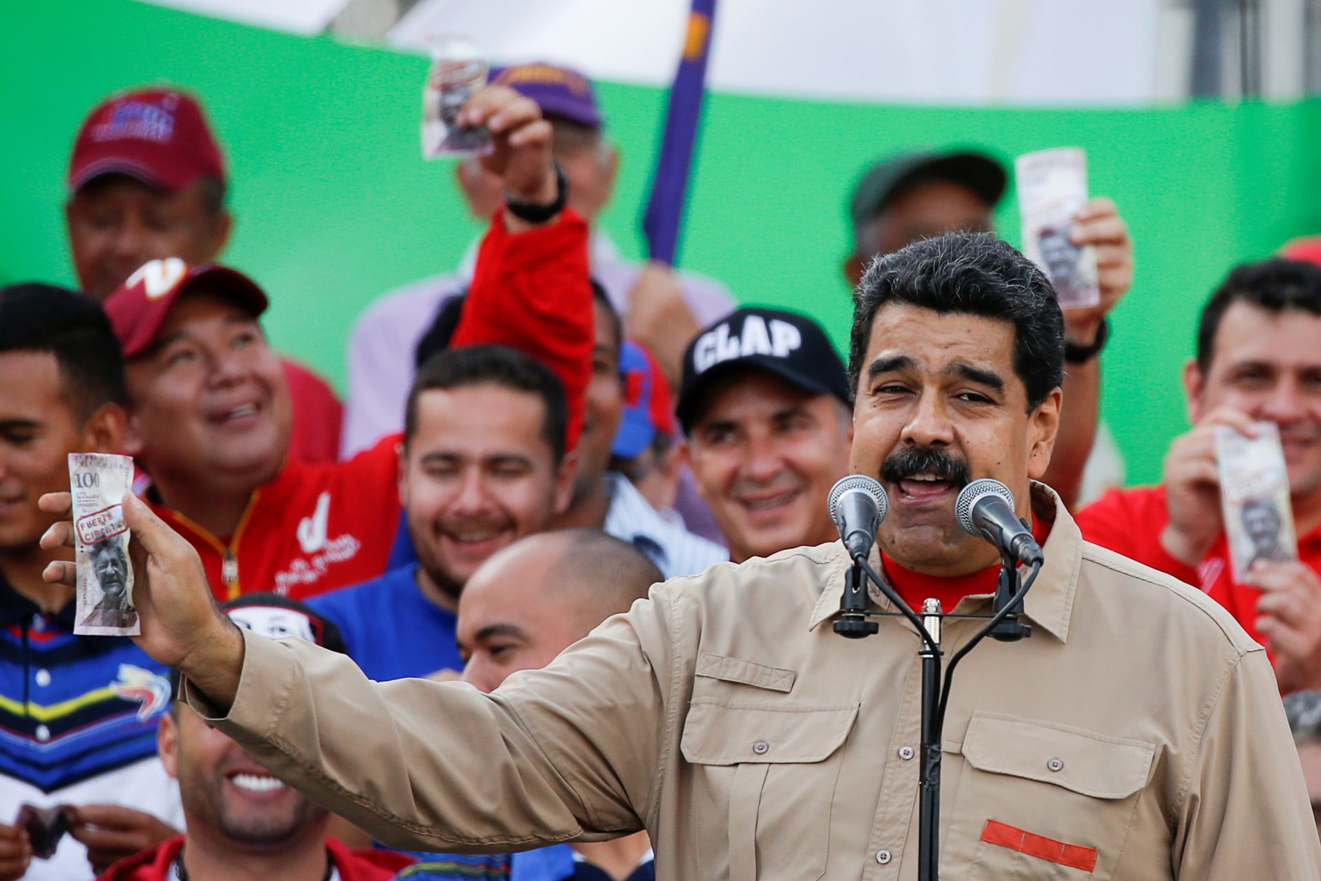 <p>Venezuela’s President Nicolas Maduro holds up a mock 100-bolivar bill depicting the president of the National Assembly Henry Ramos Allup, during a pro-government rally in Caracas, Venezuela December 17, 2016. </p>
