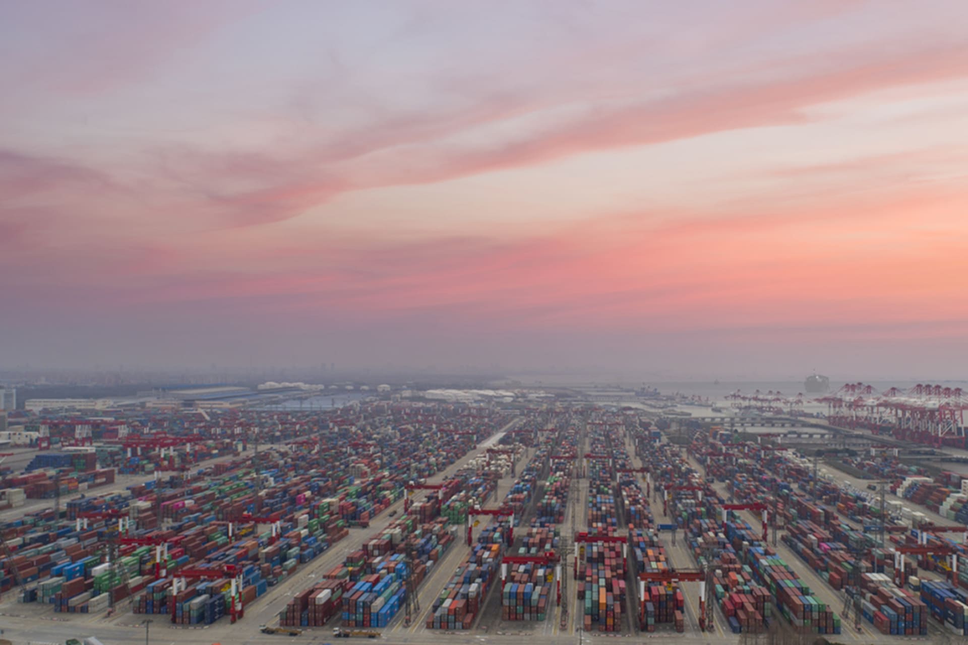 <p>The sun sets over the Port of Shanghai.</p>
