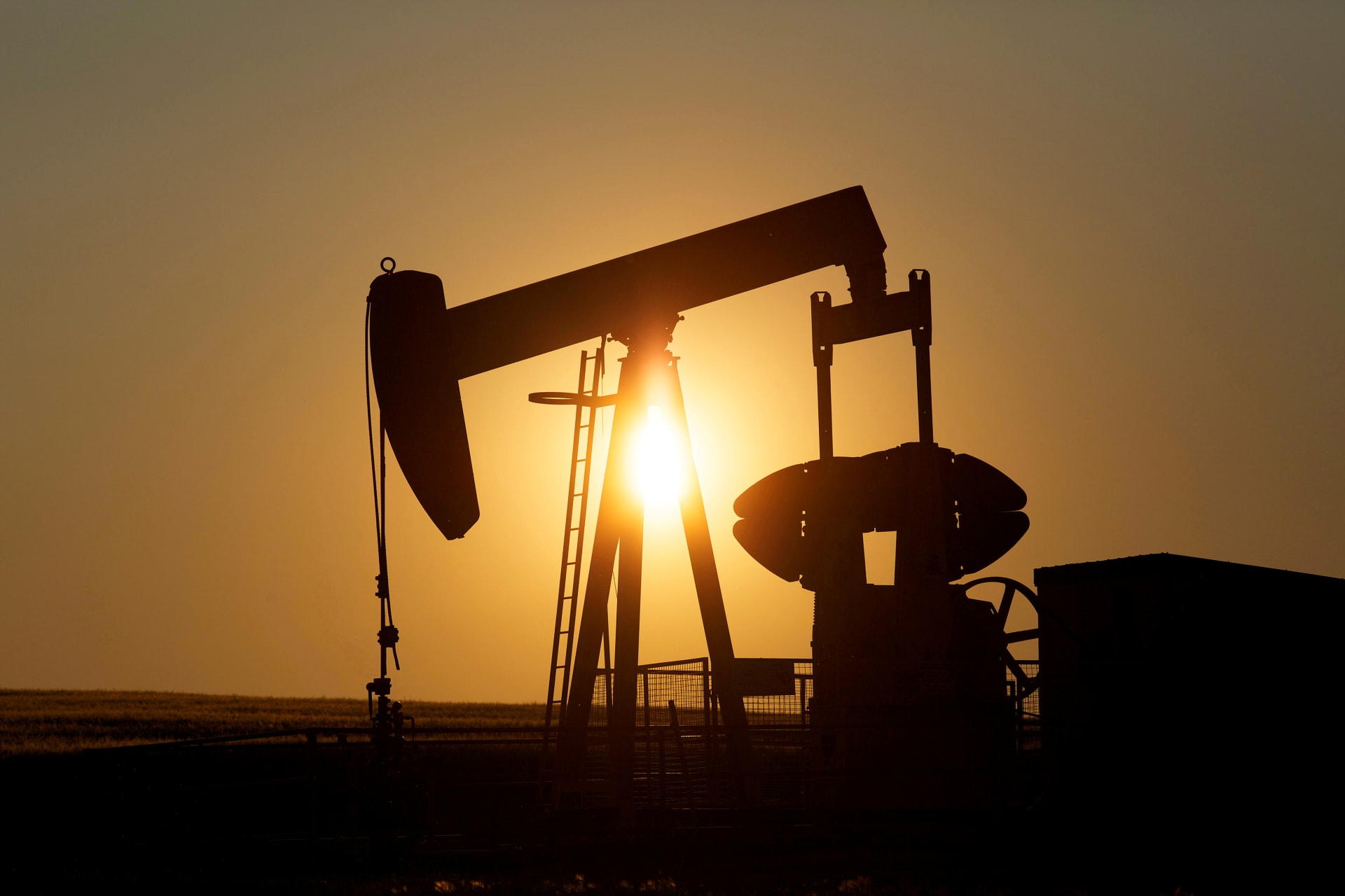 <p>An oil pump jack pumps oil in a field near Calgary, Alberta, Canada on July 21, 2014</p>
