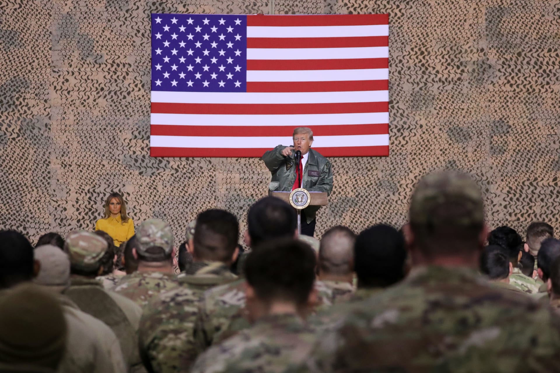 <p>U.S. President Donald Trump, with first lady Melania Trump, delivers remarks to U.S. troops in an unannounced visit to Al Asad Air Base, Iraq, December 26, 2018.</p>
