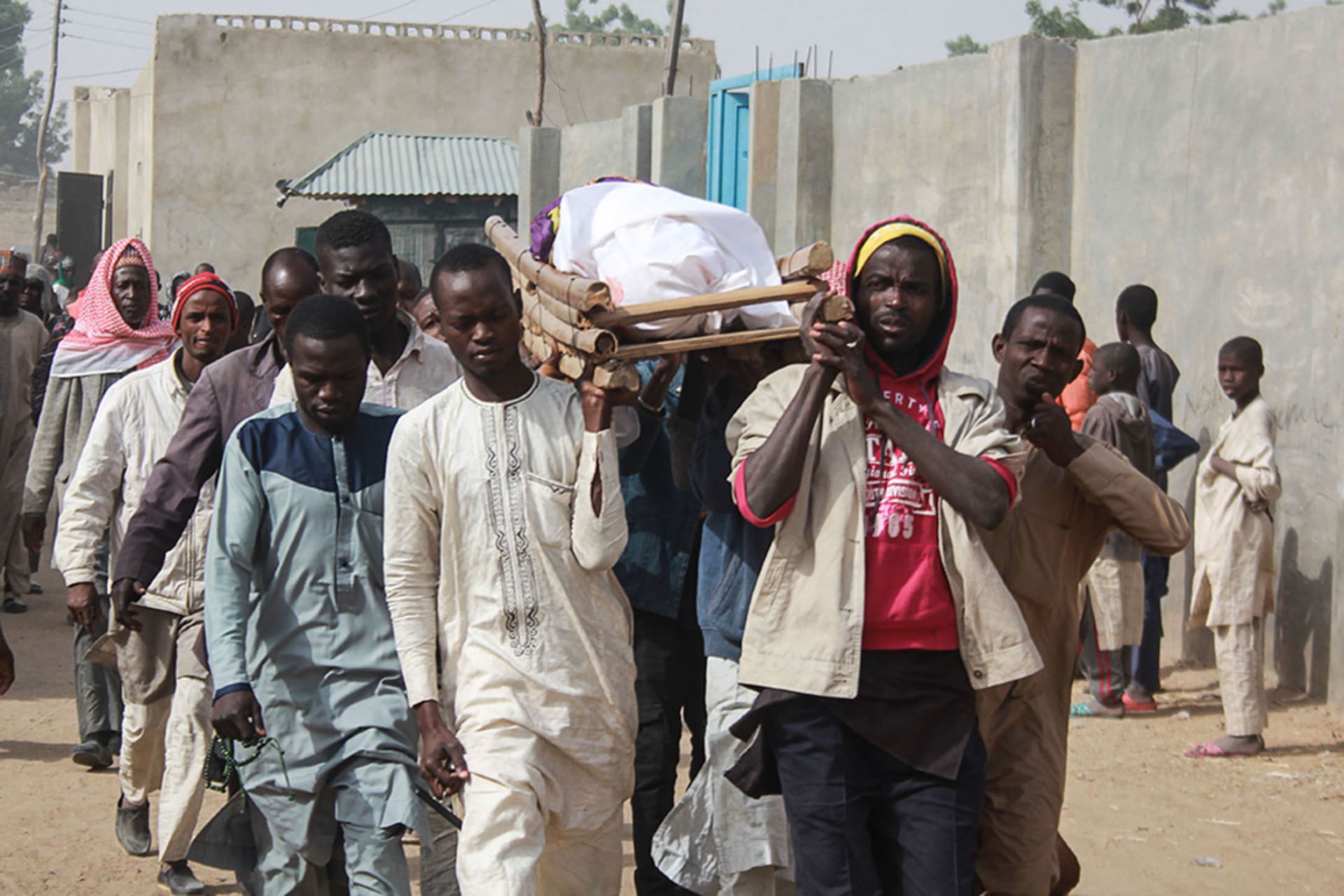 <p>People carry the body of one of Boko Haram attack victims during their burial ceremony at the Sajeri village on the outskirts of the Borno state capital, Maiduguri, on January 8, 2019.</p>