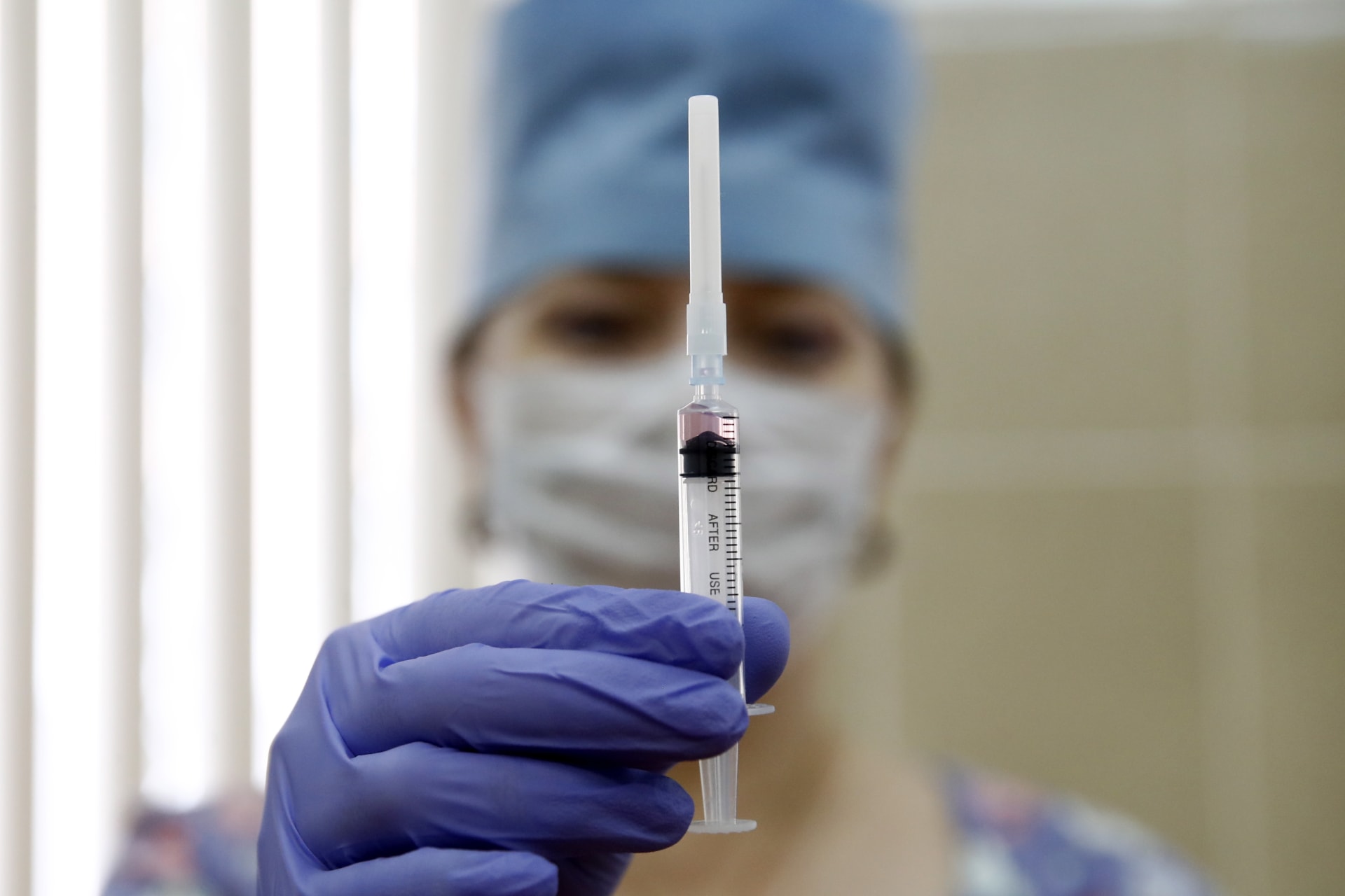 <p>A medical staff worker with a syringe containing vaccine for measles and mumps at a clinic in Moscow, Russia.</p>
