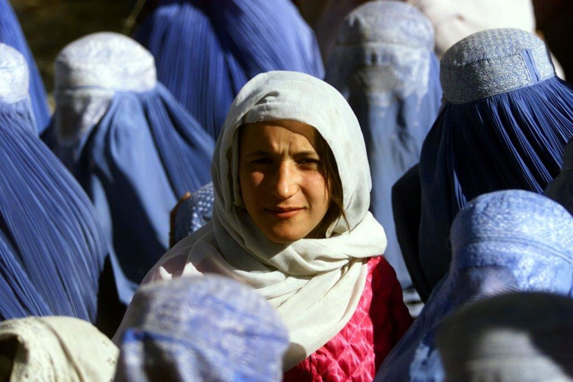 <p>A young Afghan woman shows her face in public for the first time in five years in Kabul, Afghanistan, November 14, 2001.</p>
