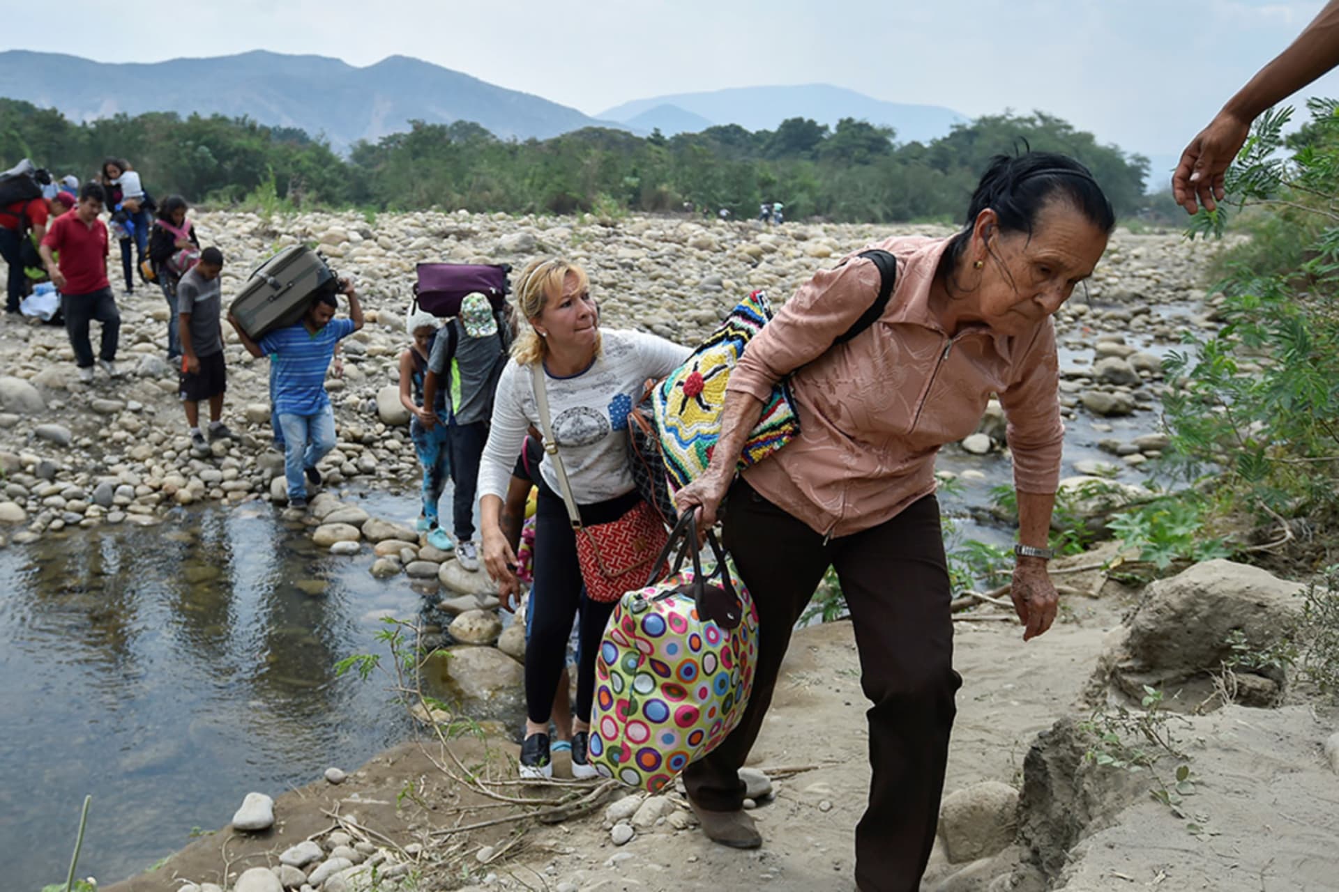 <p>Migrants cross the Tachira River from Venezuela to Colombia.</p>
