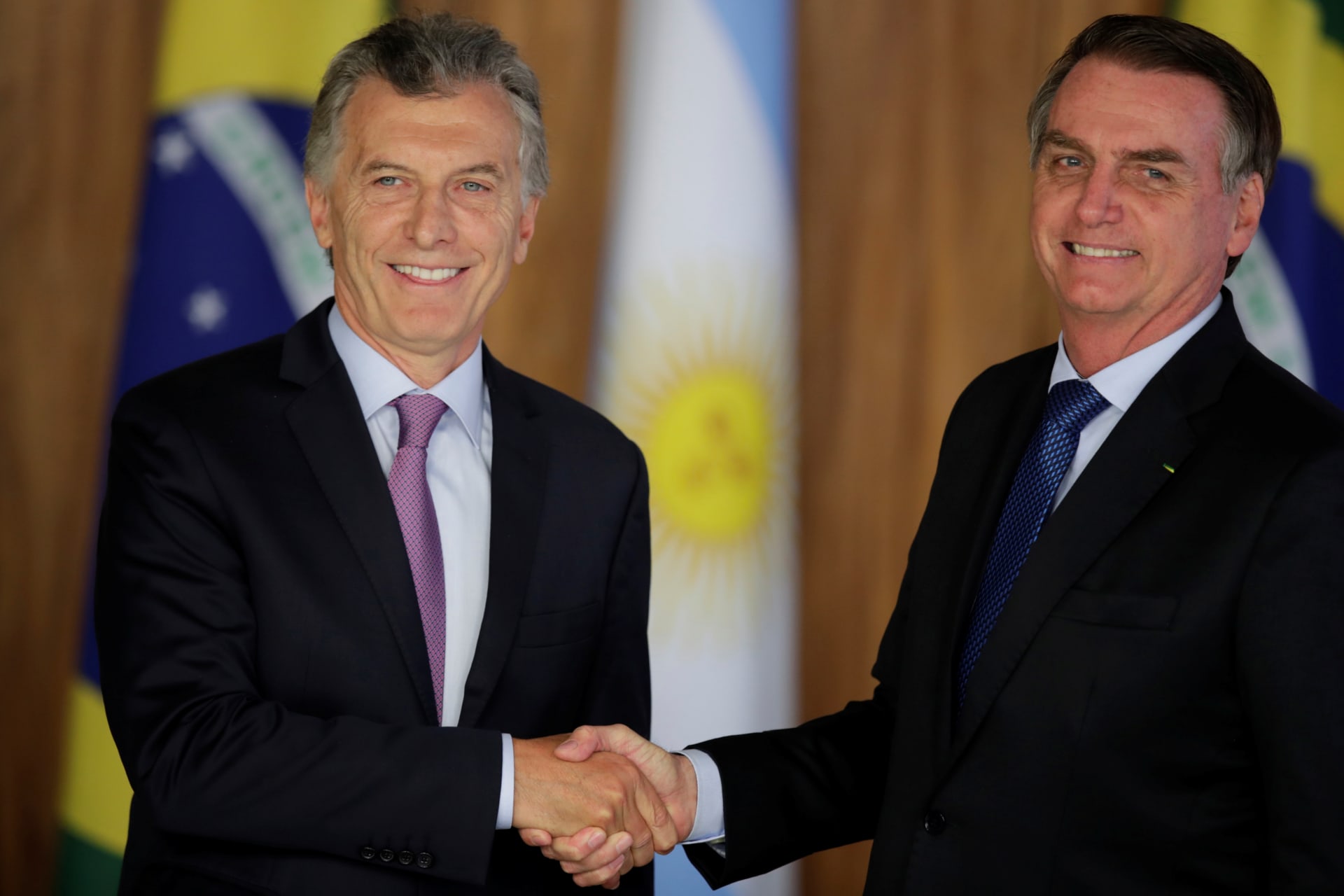 <p>Argentina’s President Mauricio Macri shakes hands with Brazil’s President Jair Bolsonaro during a meeting in Brasilia, Brazil January 16, 2019. </p>
