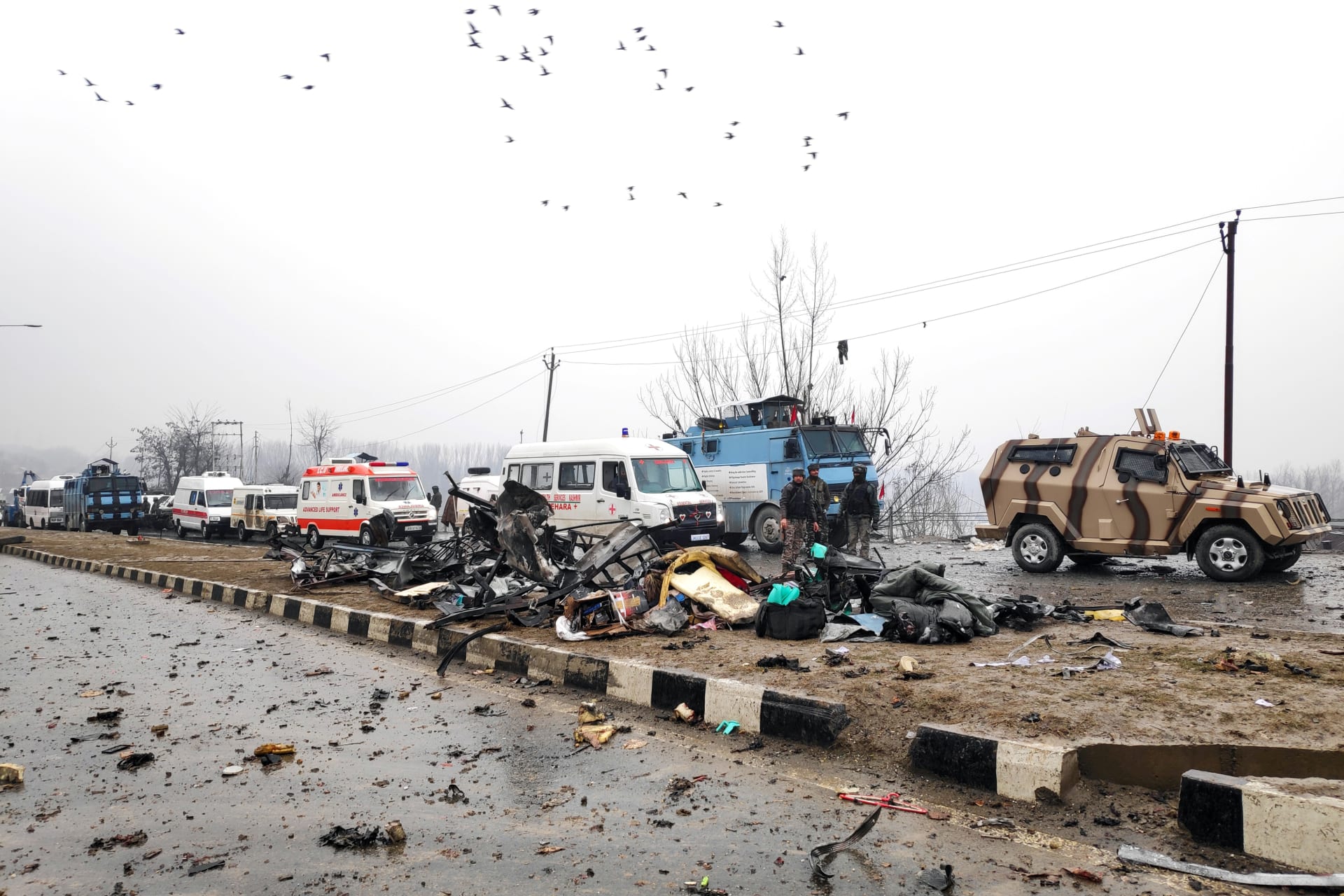 <p>Indian soldiers examine the debris after an explosion in Lethpora in south Kashmir’s Pulwama district February 14, 2019.</p>
