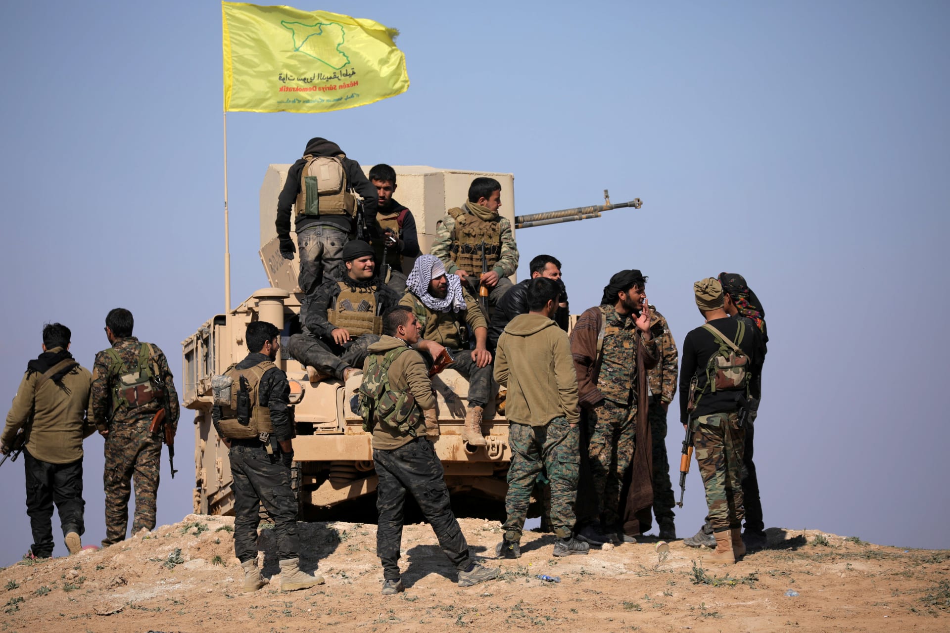 <p>Members of Syrian Democratic Forces stand together near Baghouz, Syria, on February 12, 2019.</p>
