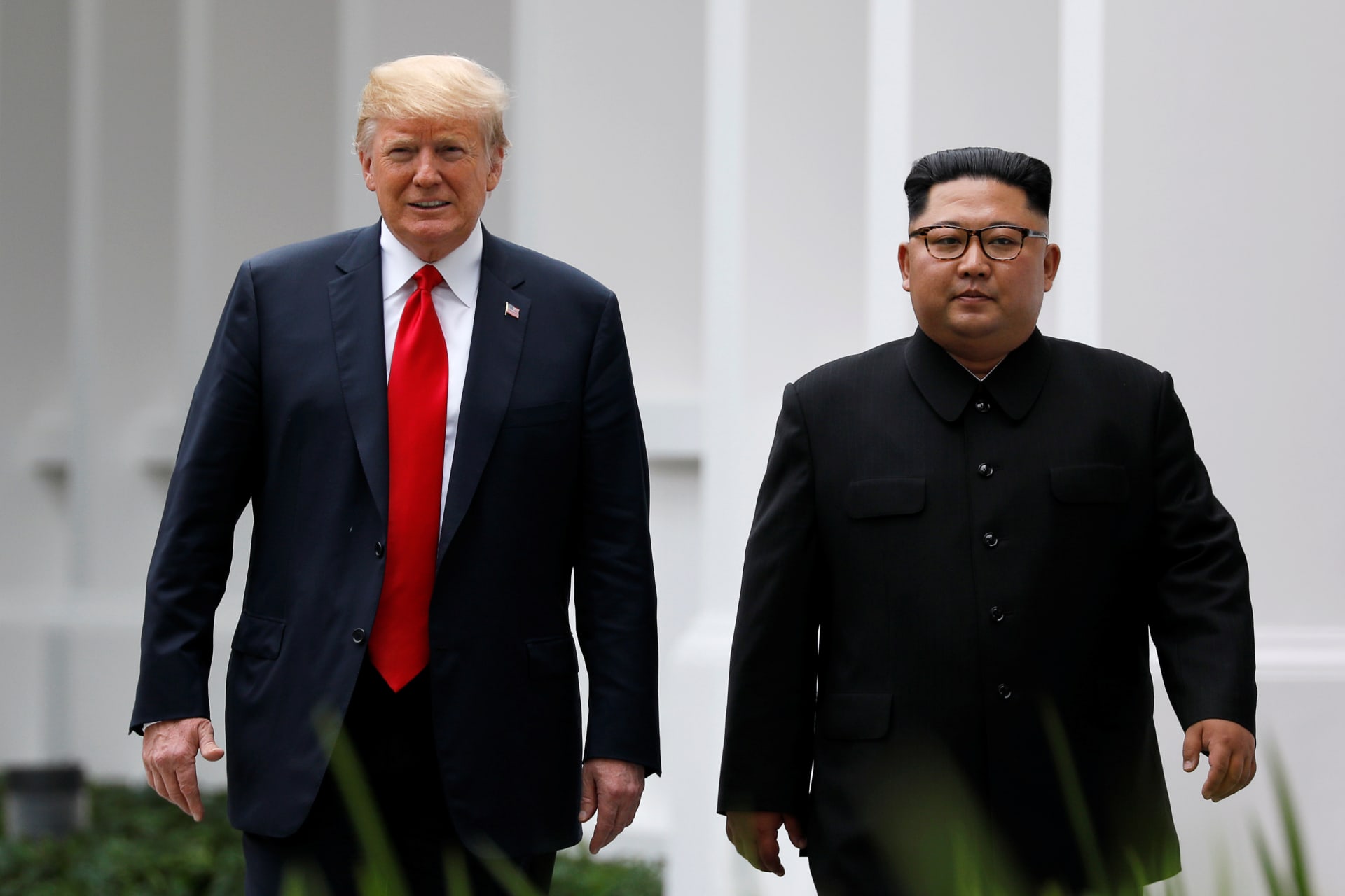 <p>U.S. President Donald Trump and North Korean leader Kim Jong-un walk after lunch at the Capella Hotel on Sentosa island in Singapore on June 12, 2018.</p>
