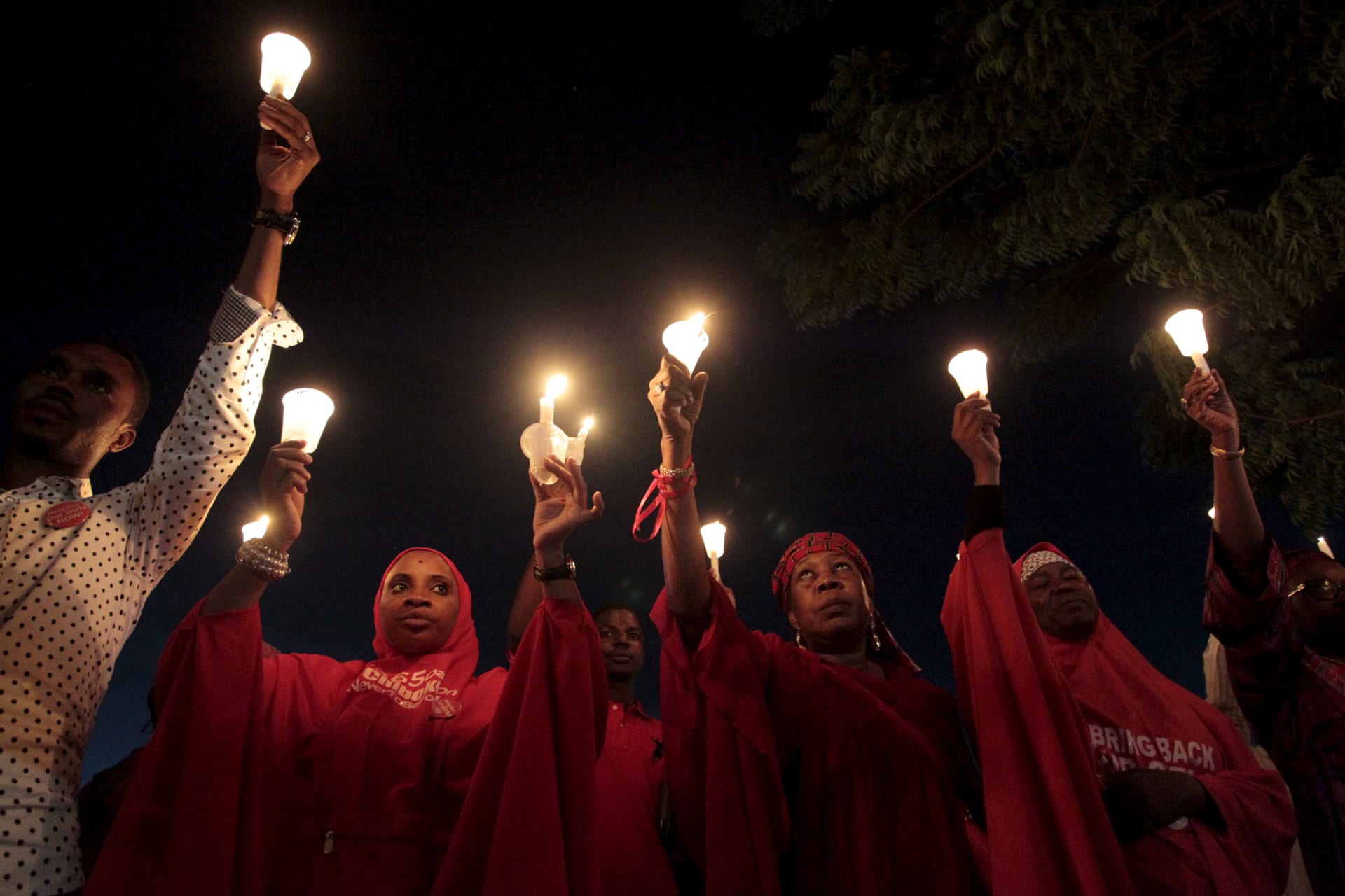 <p>#BringBackOurGirls campaigners raise candles during a candle light gathering marking the 500th day since the abduction of girls in Chibok, Nigeria. August 27, 2015. </p>
