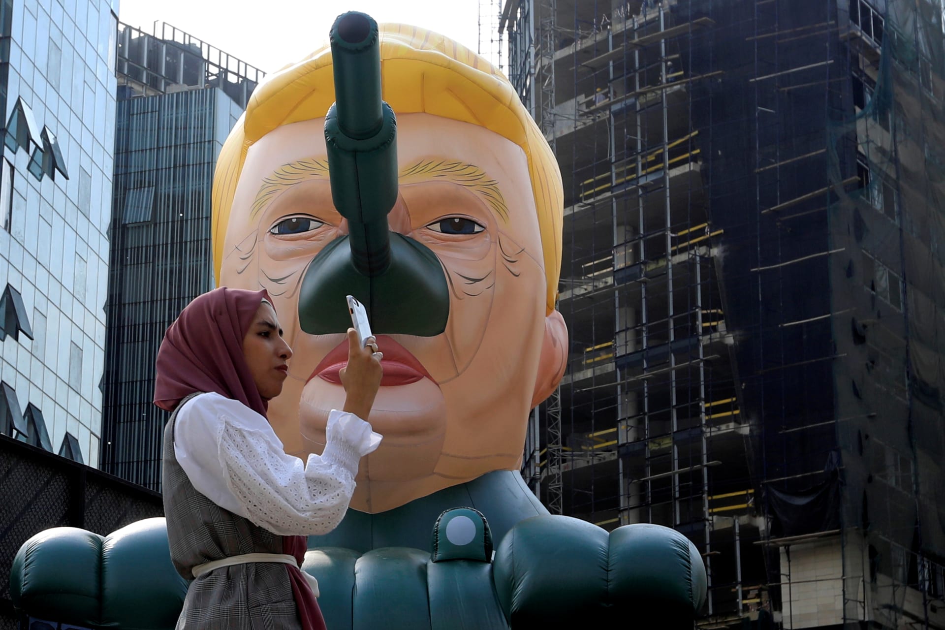 <p>A woman stands next to an inflatable tank with U.S. President Donald Trump outside an art exhibition ‘MonuMental’ by the pseudonymous artist, Saint Hoax in downtown Beirut, Lebanon October 12, 2018. </p>
