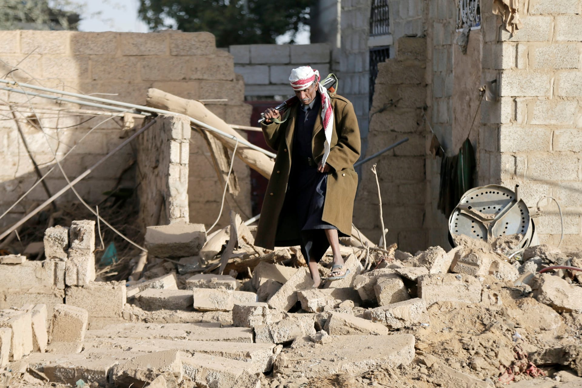 <p>A man walks at the site of a Saudi-led air strike in the Houthi-held capital Sana’a, Yemen, on January 20, 2019.</p>
