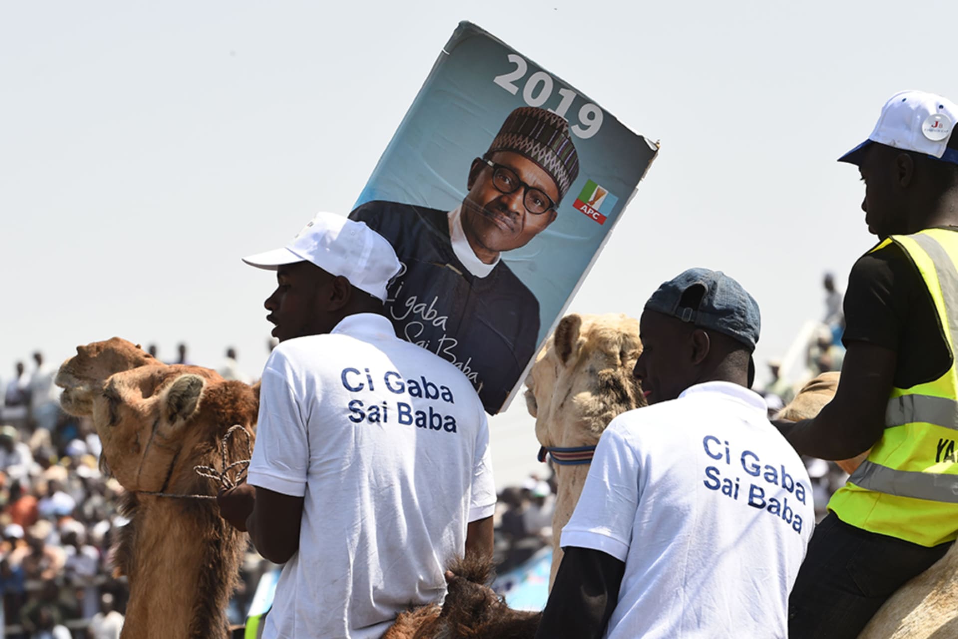 <p>Supporters sit on camels during a campaign rally for President Muhammadu Buhari in Kano.</p>

