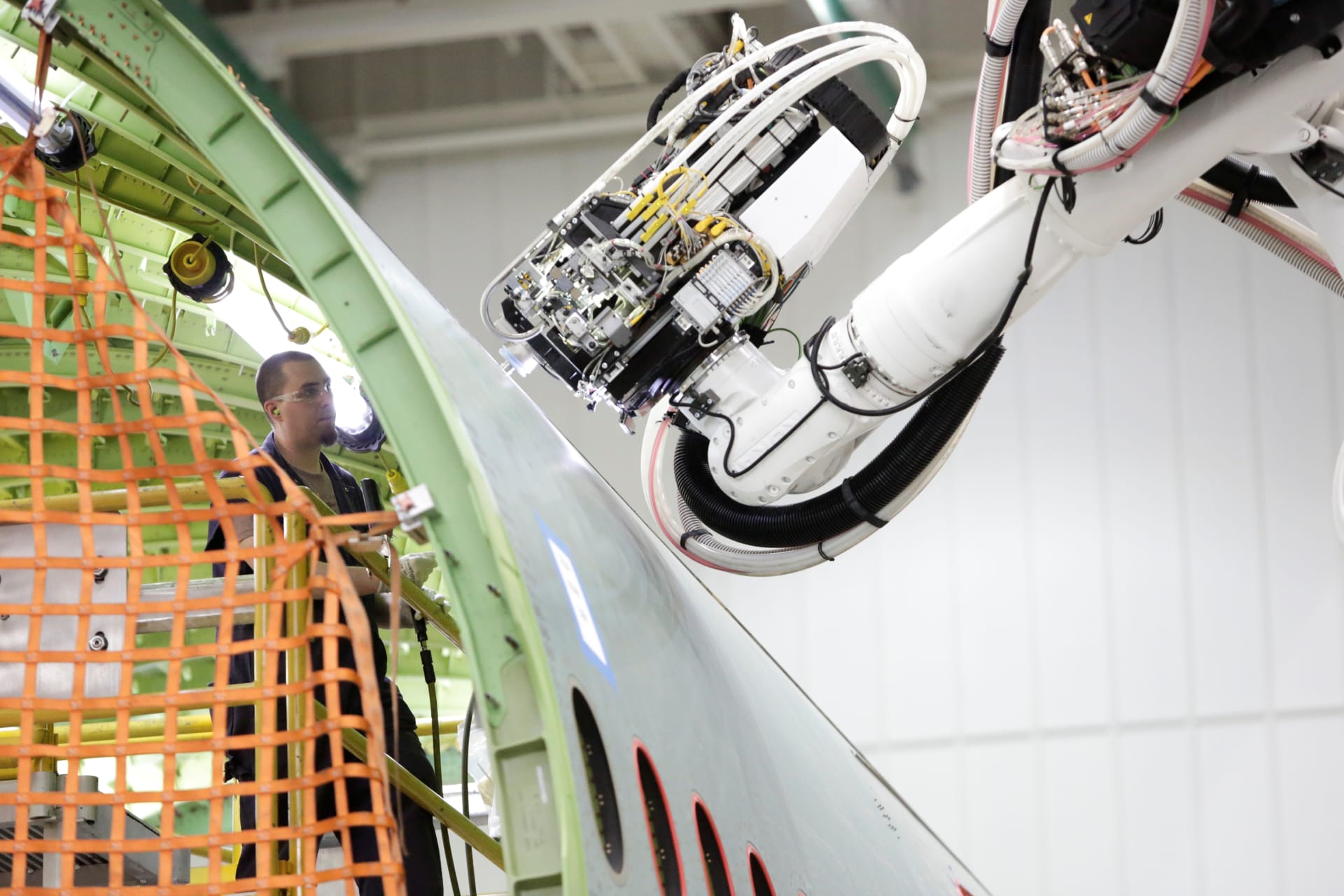 <p>A worker (L) stands inside a 777 fuselage as a machine works on the outside at the Fuselage Automated Upright Build (FAUB) and mid bodies area at Boeing’s production facility in Everett, Washington, U.S. June 1, 2017.</p>
