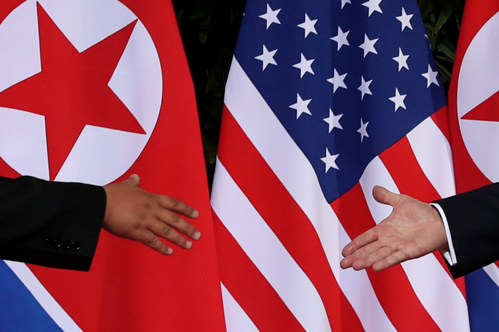 <p>U.S. President Donald Trump and North Korean leader Kim Jong-un meet at the start of their summit at the Capella Hotel on the resort island of Sentosa, Singapore on June 12, 2018.</p>
