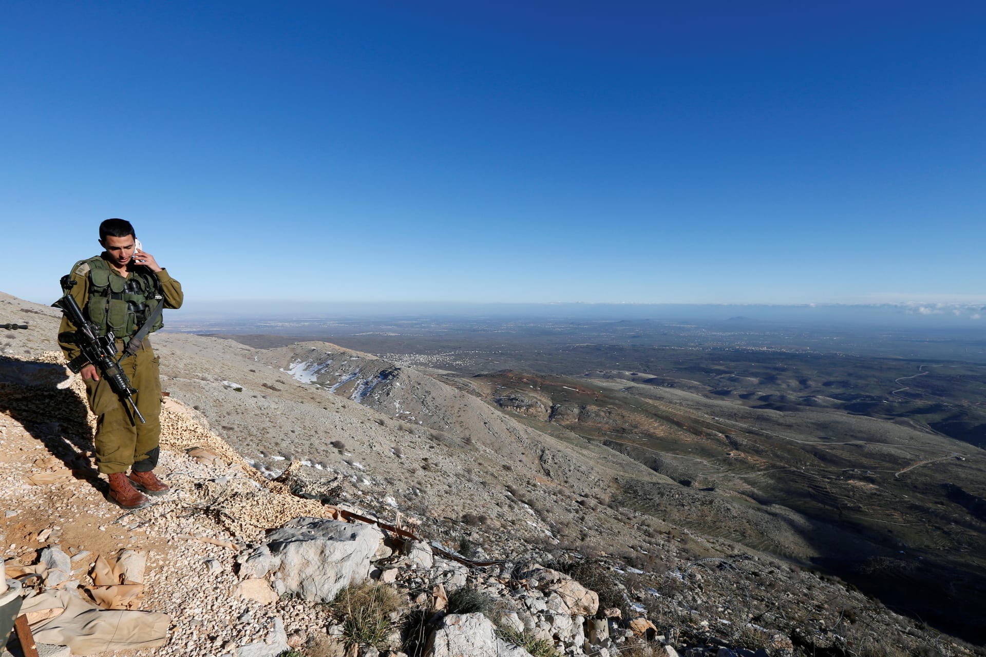 <p>An Israeli soldier speaks on his mobile phone at a military outpost on Mount Hermon in the Golan Heights over looking the Israel-Syria border February 4, 2015.</p>
