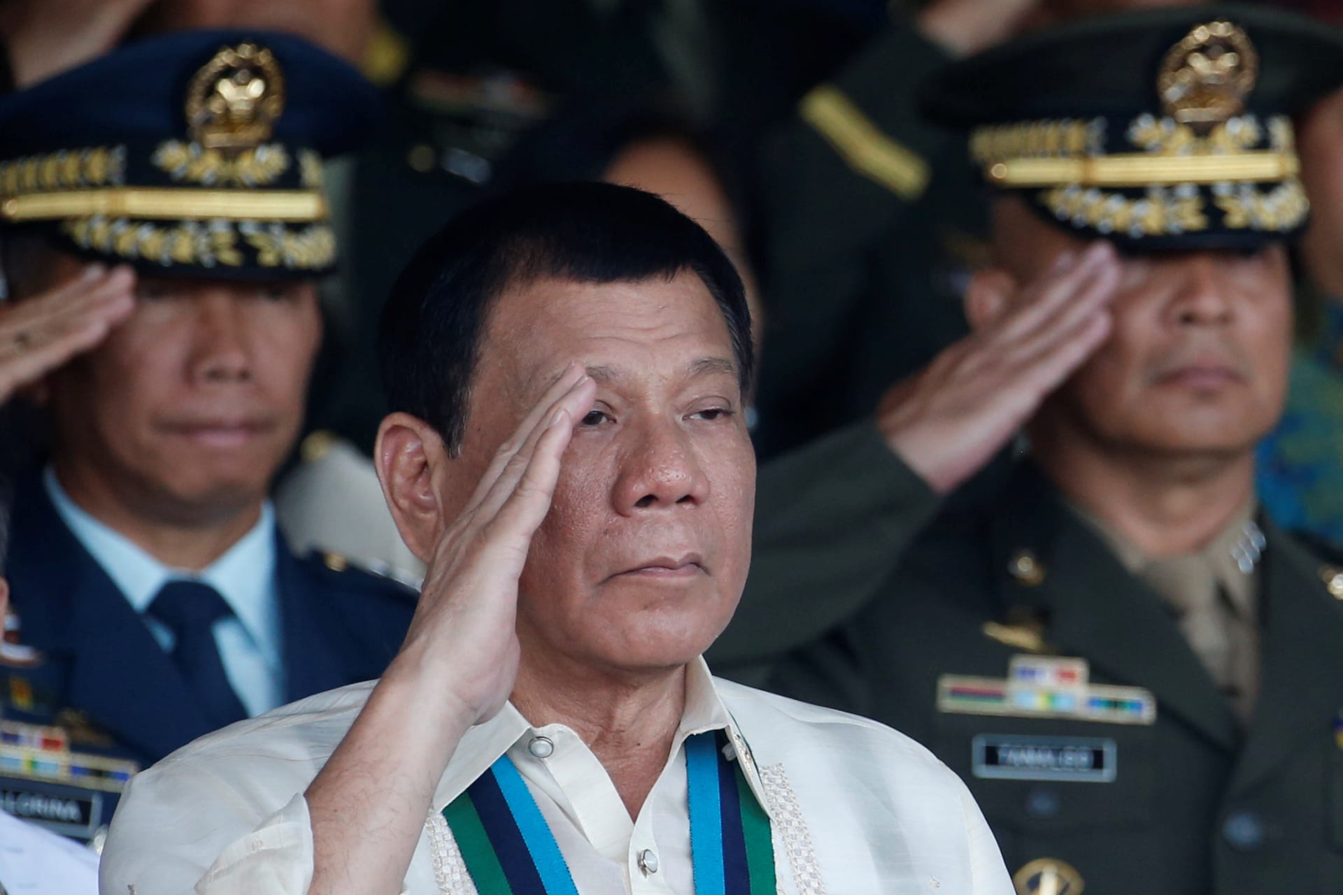 <p>Philippine President Rodrigo Duterte salutes with other military officers during a anniversary celebration of the Armed Forces at a military camp in Quezon city, Metro Manila on December 21, 2016.</p>
