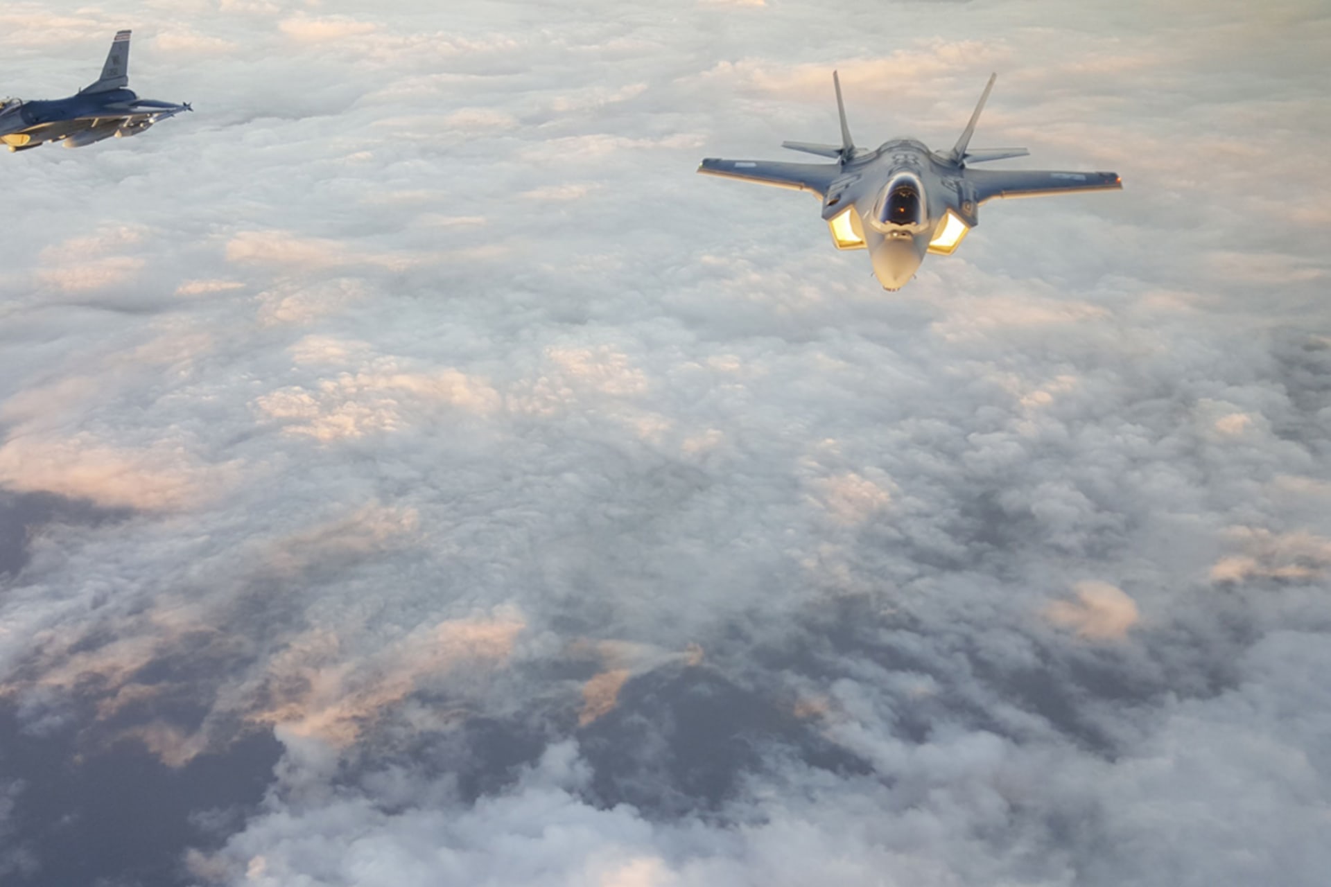 <p>A U.S. Air Force F-16 (left) escorts a Japan Air Self-Defense Force F-35A (right) over the Pacific Ocean on November 6, 2017.</p>
