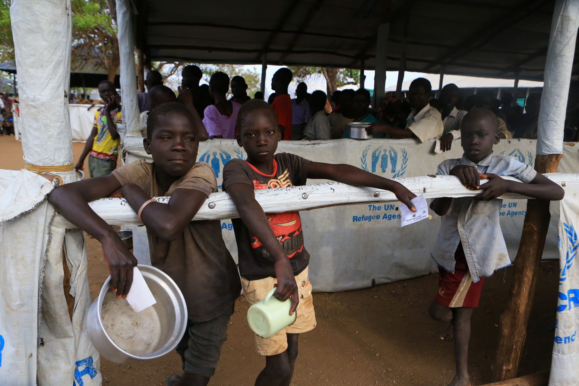 <p>South Sudanese refugee children displaced by fighting hold utensils as they wait for a warm meal at Imvepi settlement in Arua district, northern Uganda, on April 4, 2017. </p>

